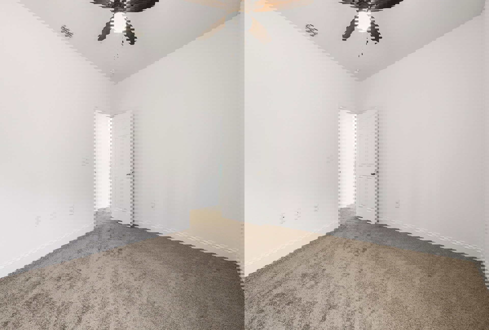 Carpeted room with white walls, ceiling fan with light fixture, and white door featuring a silver handle