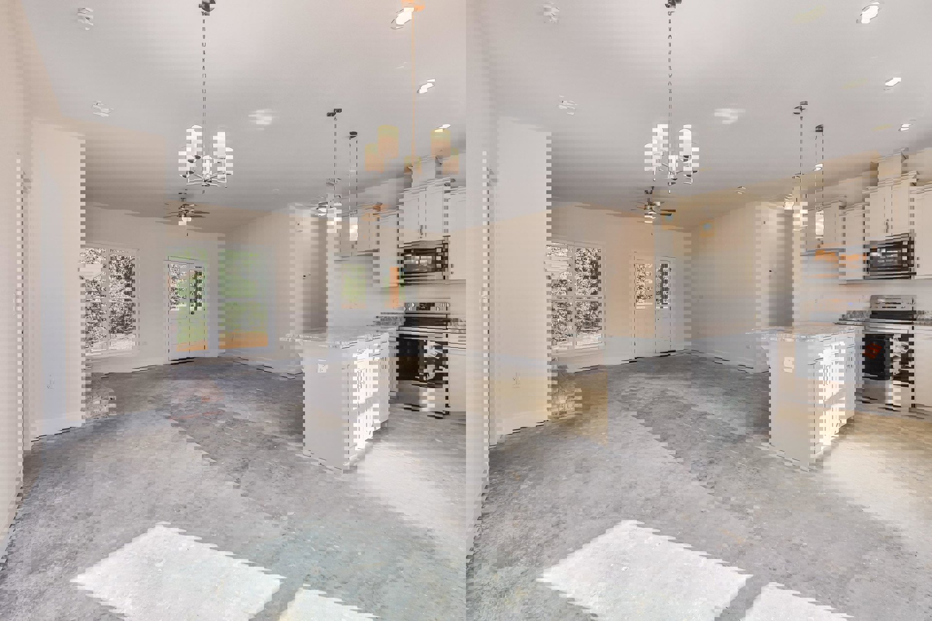 Spacious open-plan room featuring hardwood floors, white cabinetry kitchen with stainless steel appliances, stone fireplace, mirrored double doors, and large windows with white