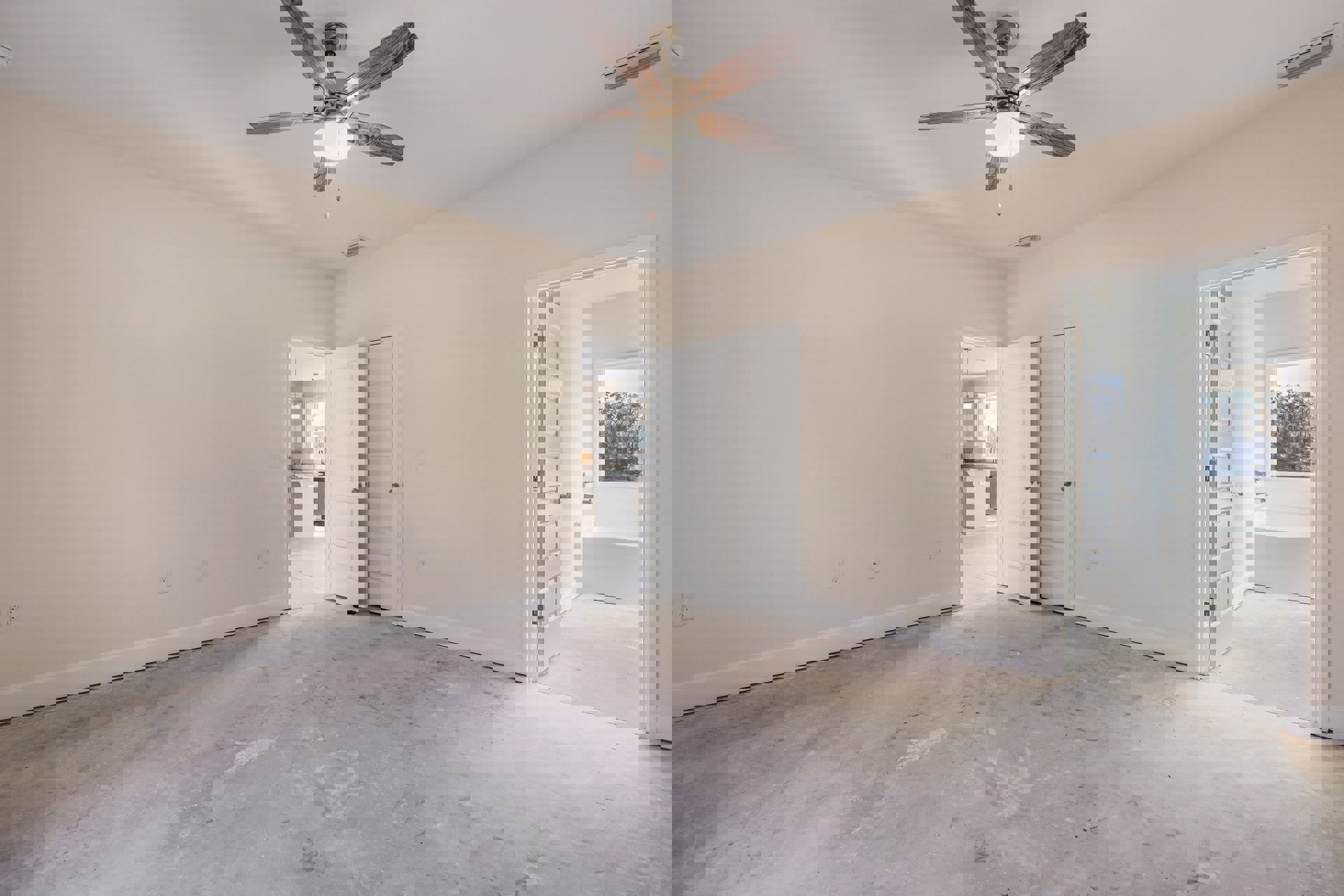 Neutral-toned room with two ceiling fans featuring light fixtures, white plaster walls, white door with silver doorknob, and smooth flooring