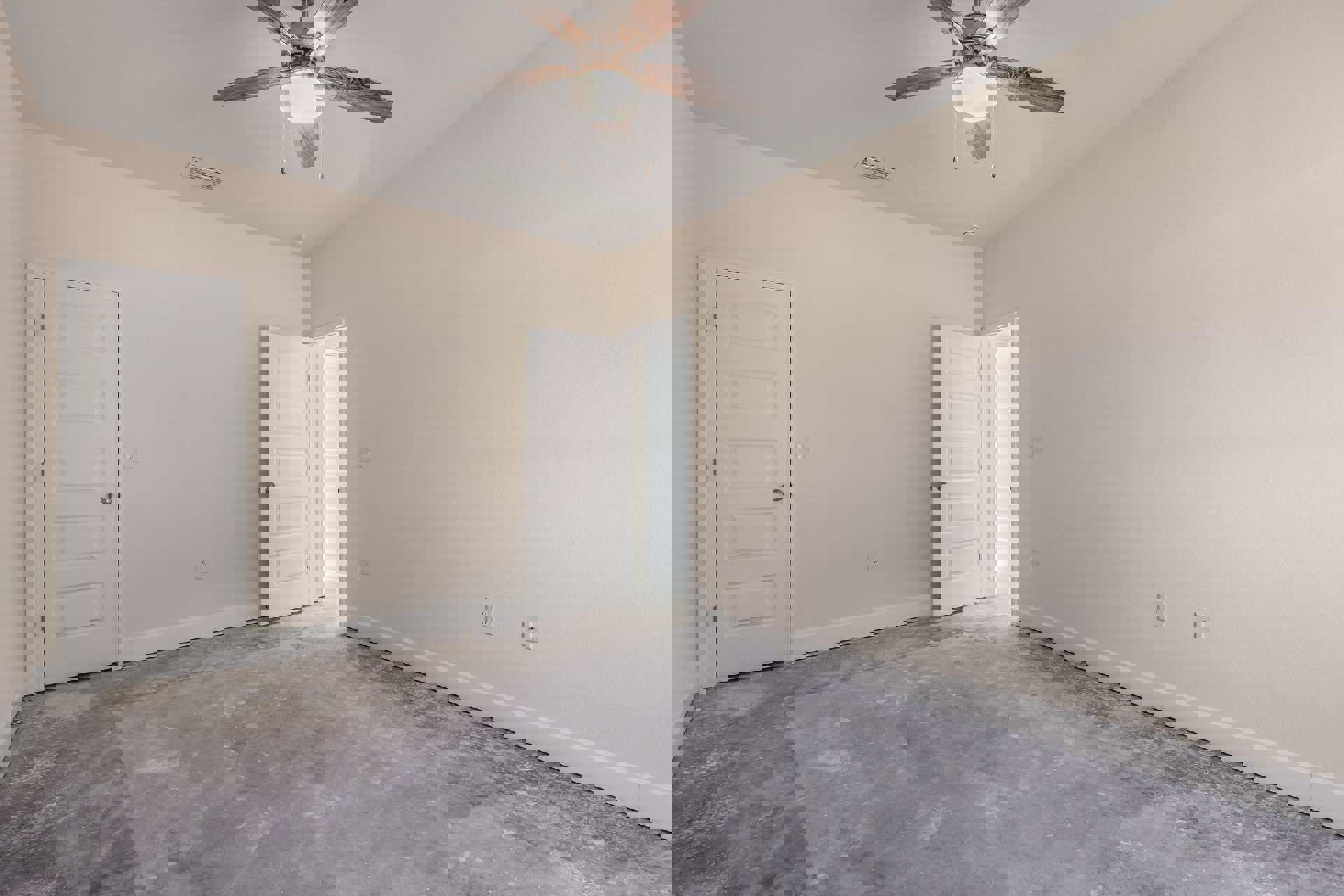 Ceiling fan with integrated light fixture mounted on white plaster ceiling above concrete floor, white door with silver knob and frame open to adjacent room
