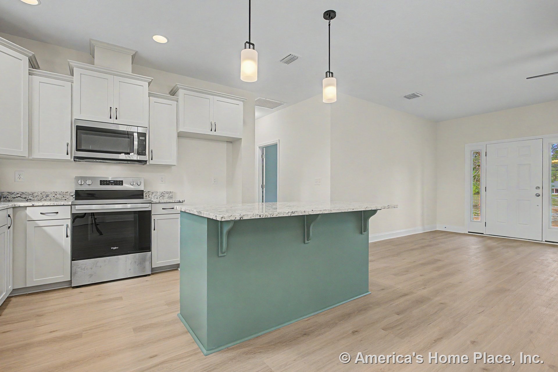 White shaker cabinets and marble-look countertops with a teal kitchen island, pendant lights overhead, stainless steel appliances, light wood flooring, and open layout with entry