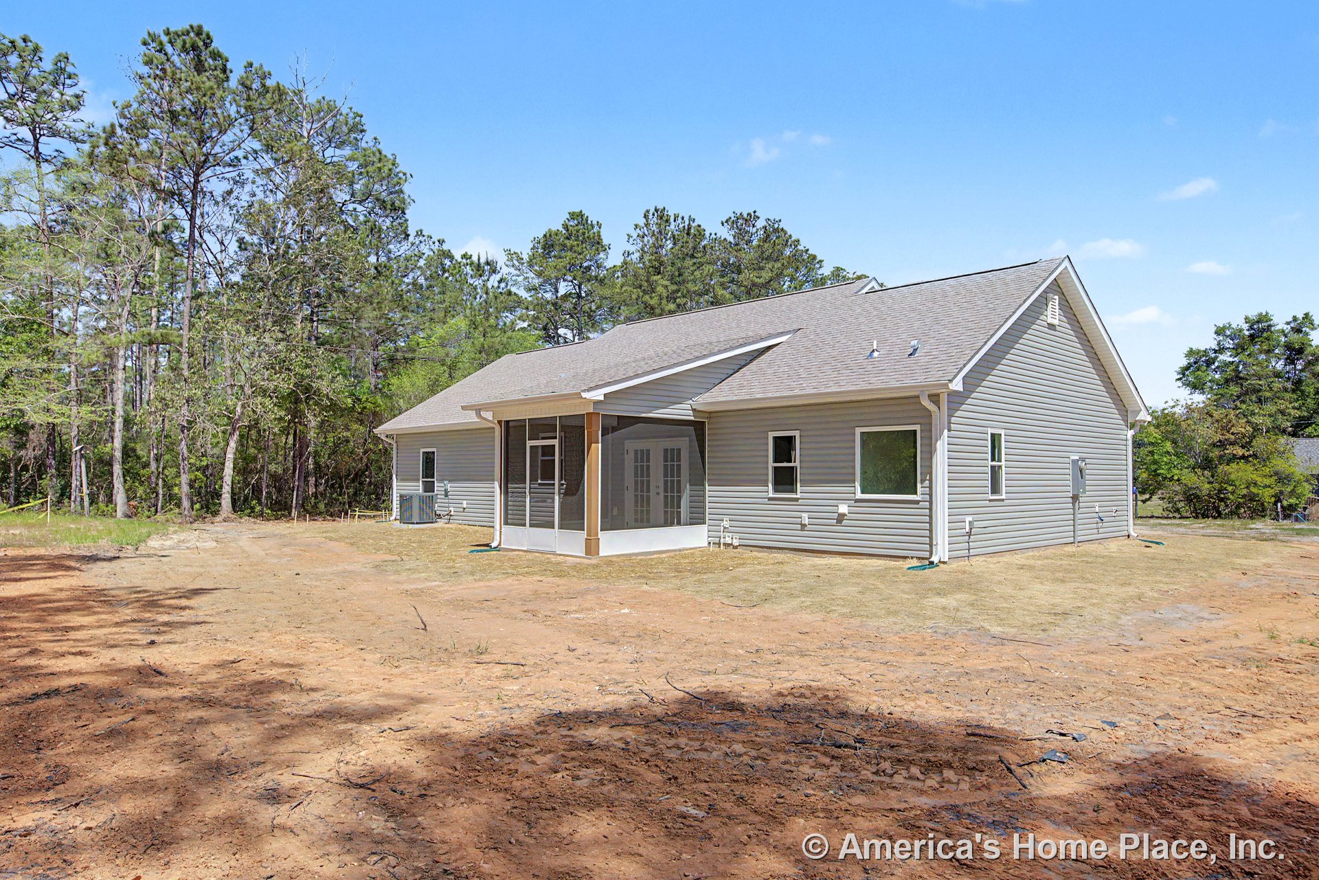 Screened porch with double French doors, gray vinyl siding, gable roof, white trim, and multiple windows on new residential exterior