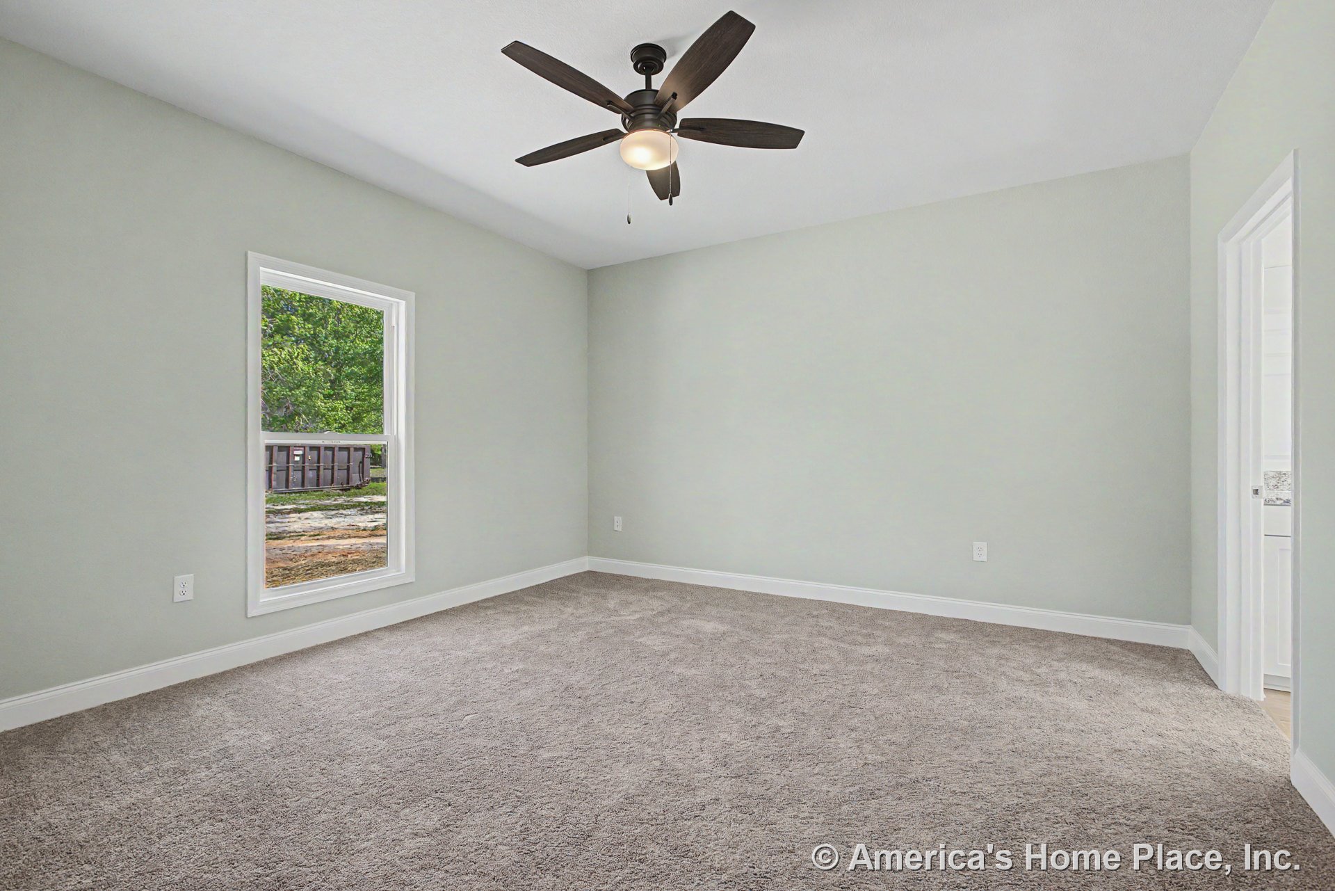 Bedroom with light gray carpet flooring, white baseboard trim, single window allowing natural light, ceiling fan with integrated light fixture, light gray painted walls, and