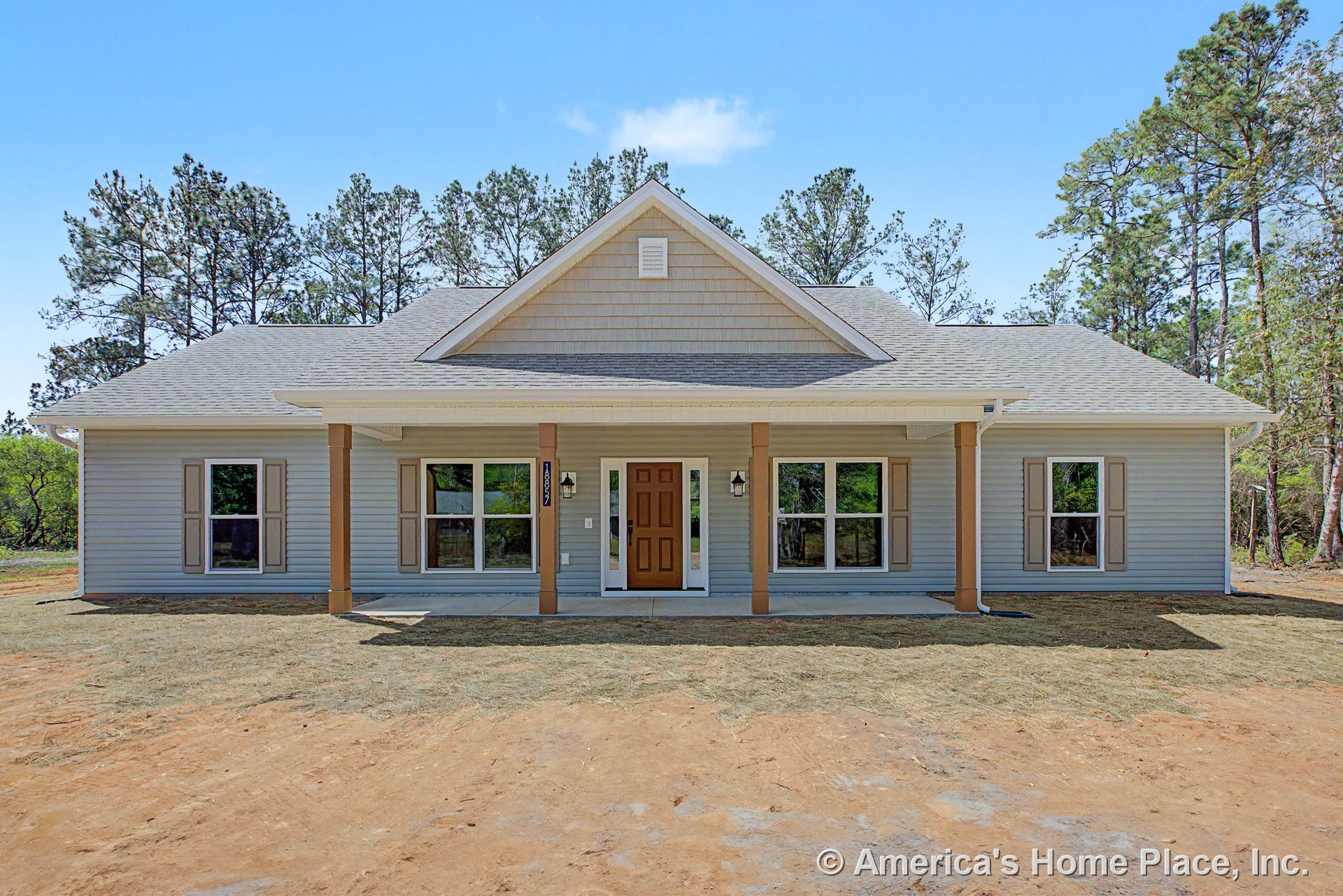 Covered front porch with four support columns, double front entry lights, multiple large windows with shutters, gable roof featuring vent, horizontal siding exterior, and