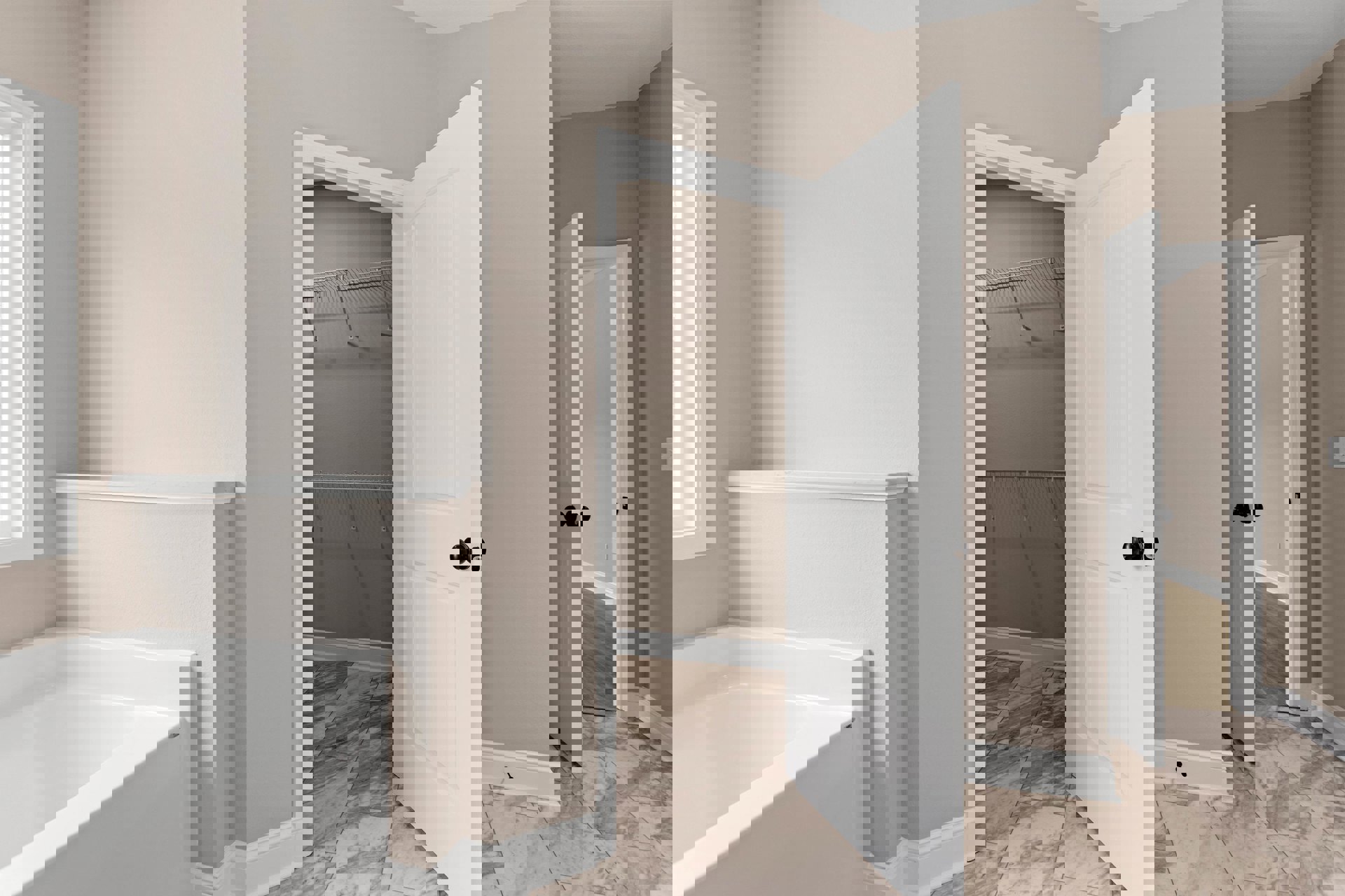 Walk-in closet with white shelves, metal rods, wooden floor, and white door with black knob adjacent to bathroom featuring white bathtub and tiled walls