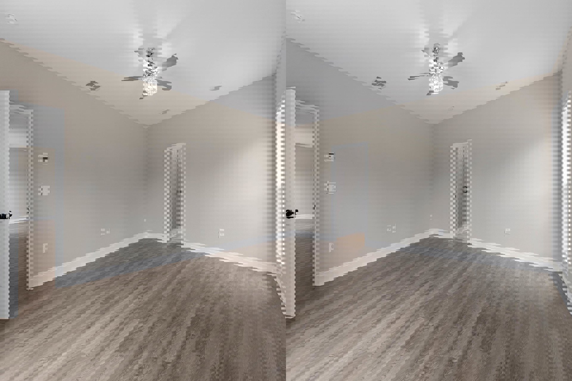 Ceiling fan with crystal light fixture above hardwood floor, glass door with handle, white walls, and natural light streaming through rectangular window