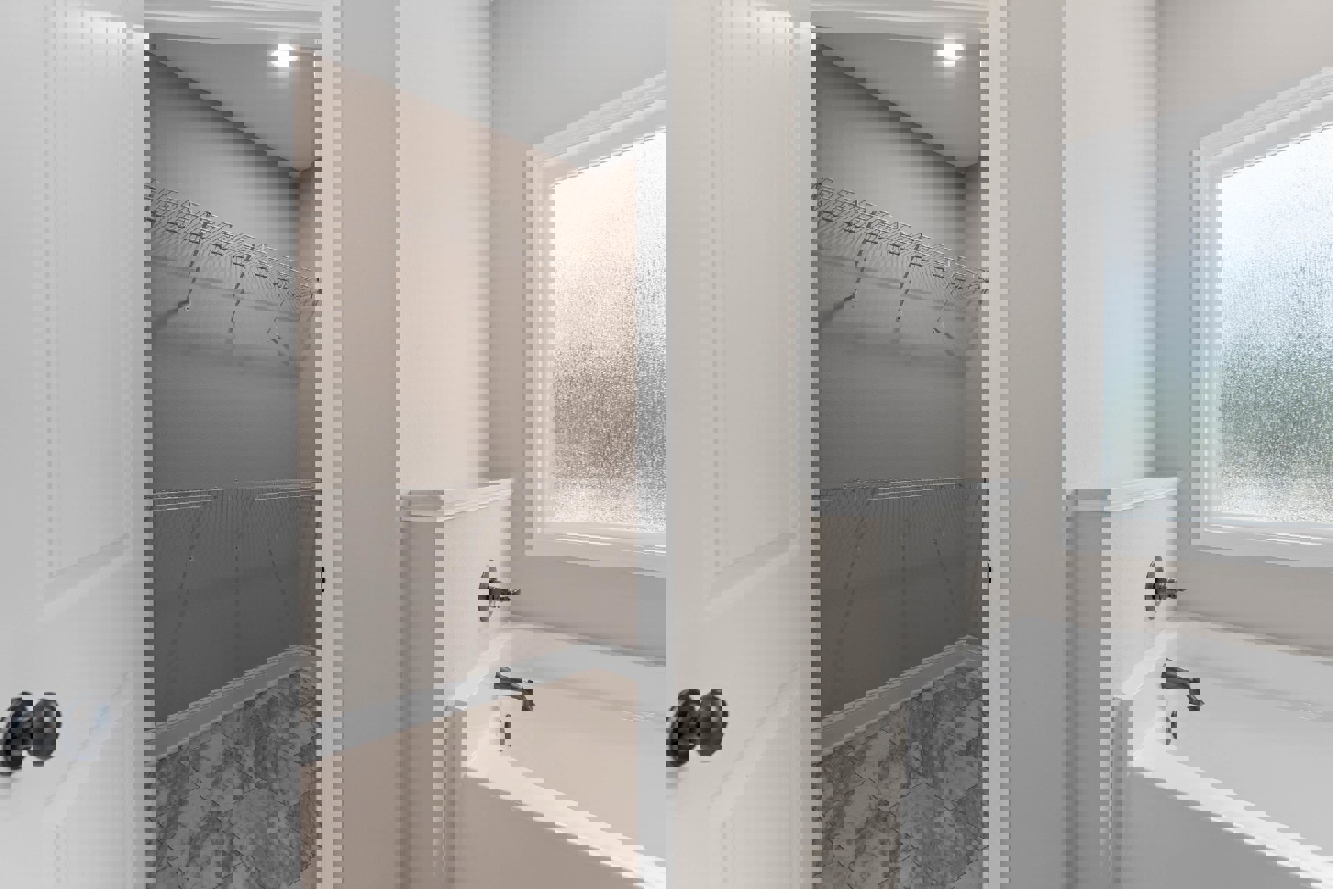 Bathroom with freestanding bathtub and chrome faucet, glass-enclosed shower, marble tile floor, white baseboard, frosted glass window, white wall shelf, close-up of brushed metal