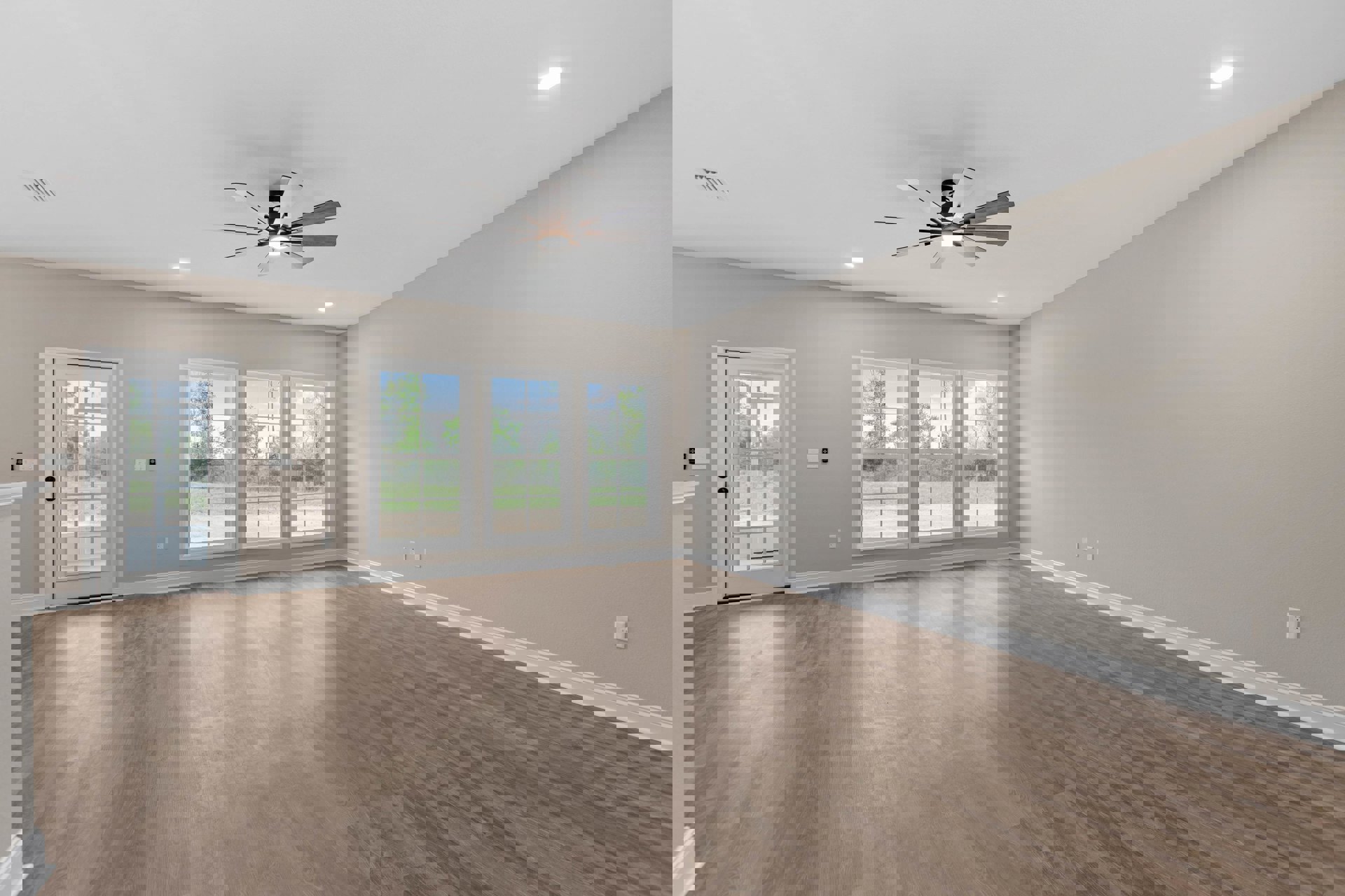 Ceiling fan with light fixture, wood flooring, white walls, glass-paneled white door, row of windows overlooking trees