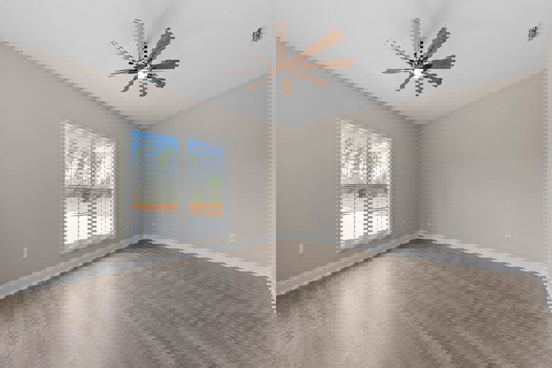 Ceiling fan with light fixture, large window overlooking green trees, wood flooring, white plaster walls, ceiling vent