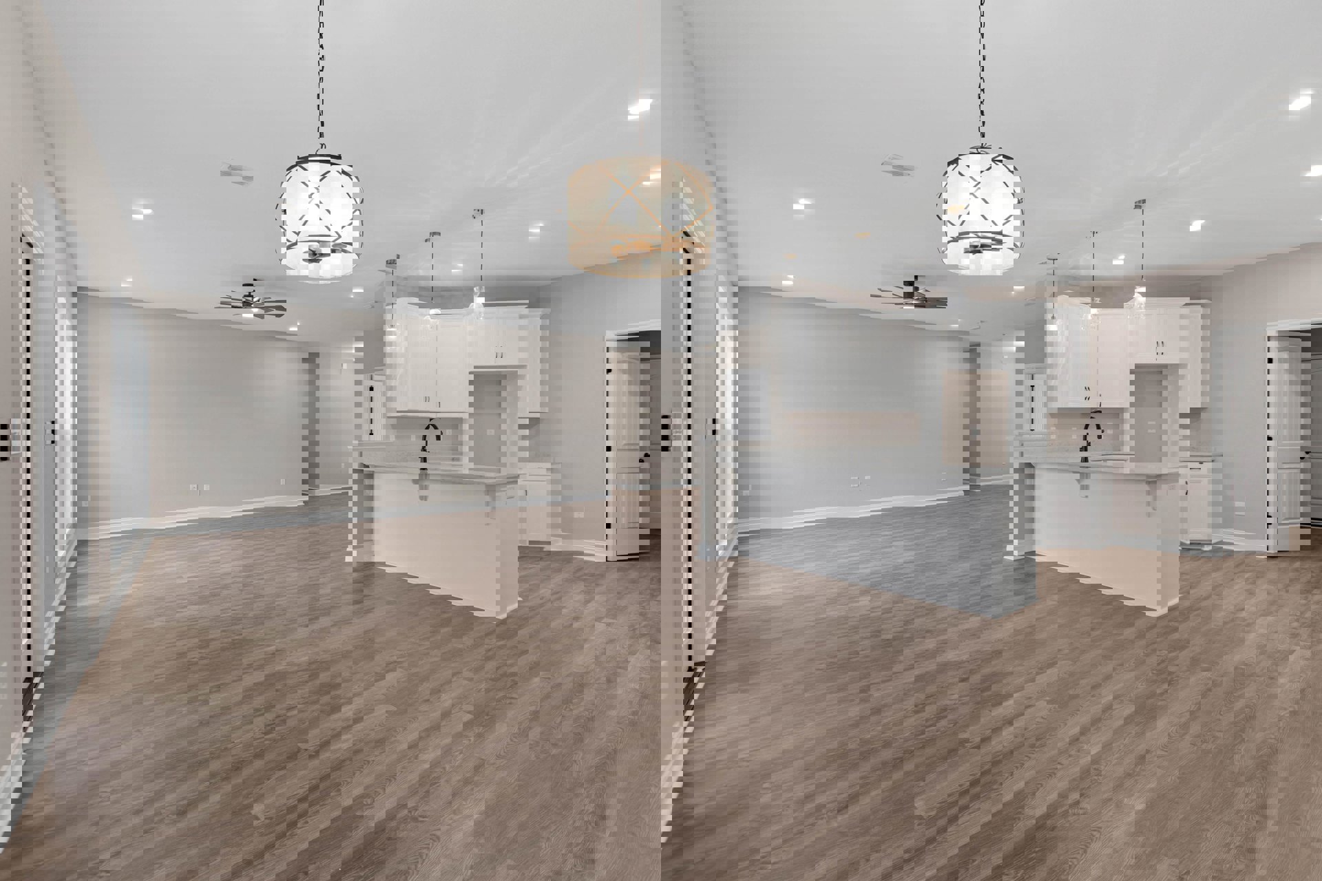 Open-concept kitchen with wood flooring, white walls, black faucet, ceiling fan, and modern light fixture