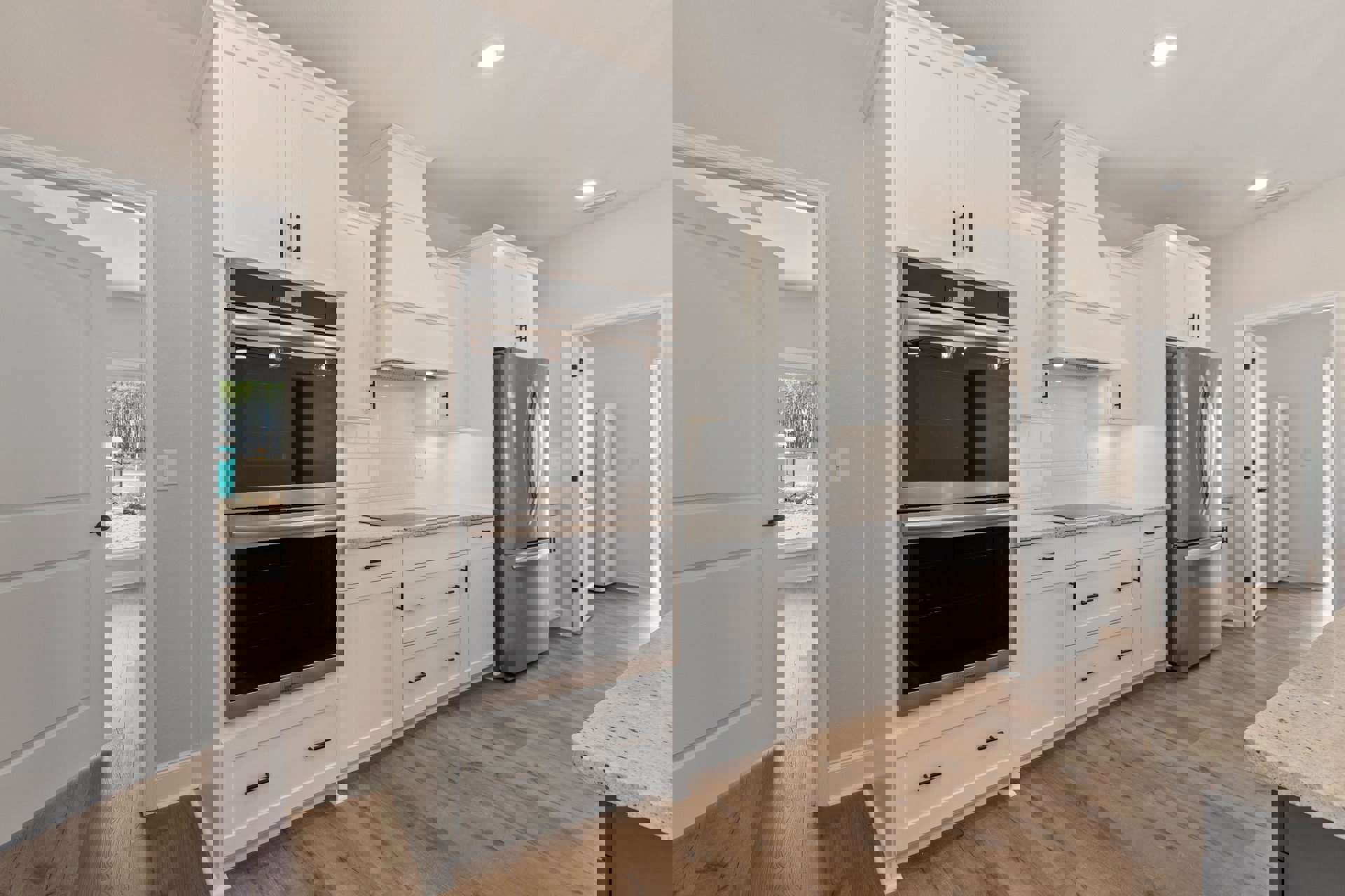 White kitchen cabinets, stainless steel refrigerator and oven, glass window with ceiling light, light-colored flooring