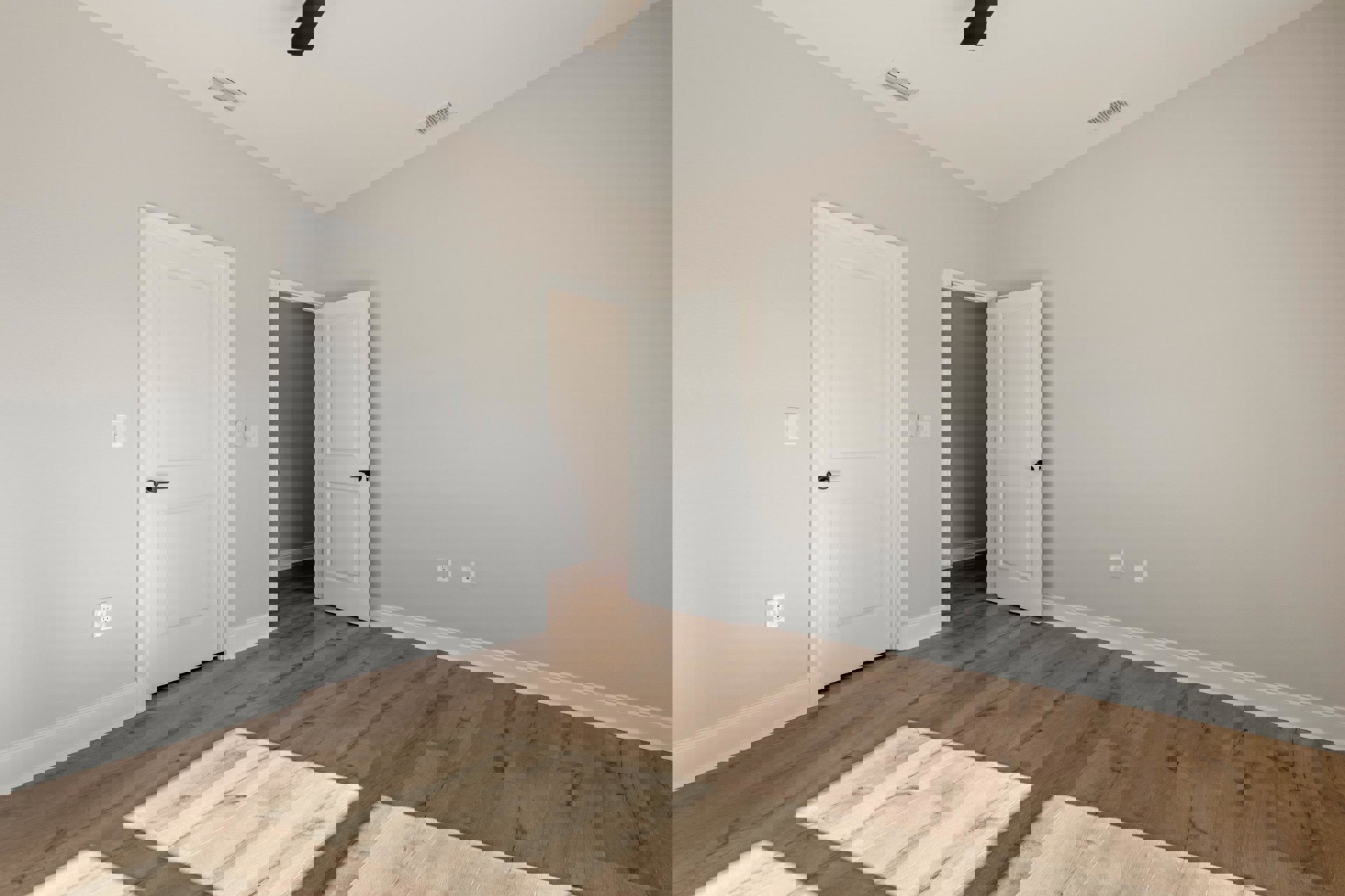 Wood flooring with two white paneled doors, black handles, white walls, ceiling fan, and ceiling vent