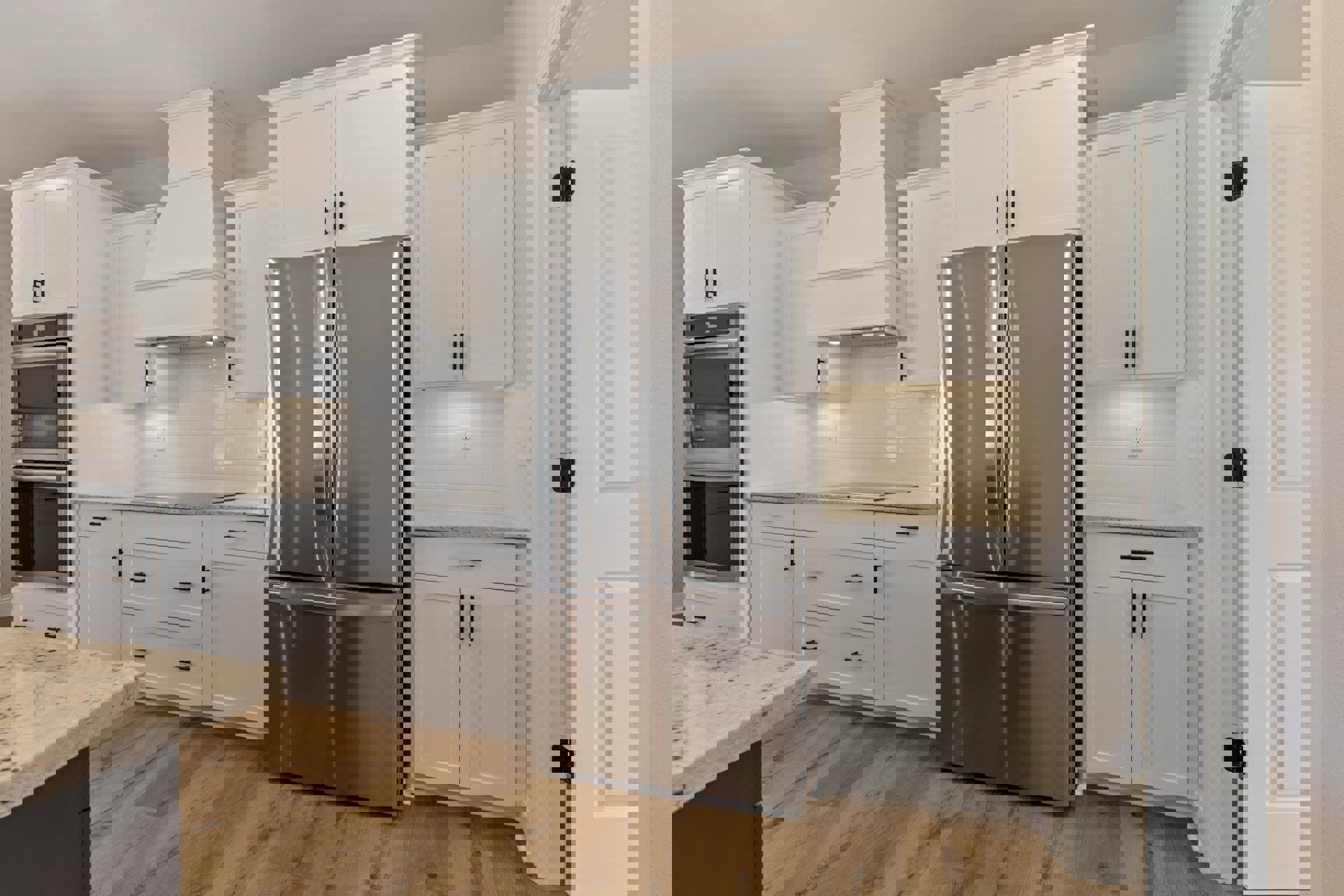 White shaker cabinets, stainless steel French door refrigerator, wood flooring, quartz countertops, built-in oven, and modern drawer pulls in a bright kitchen.