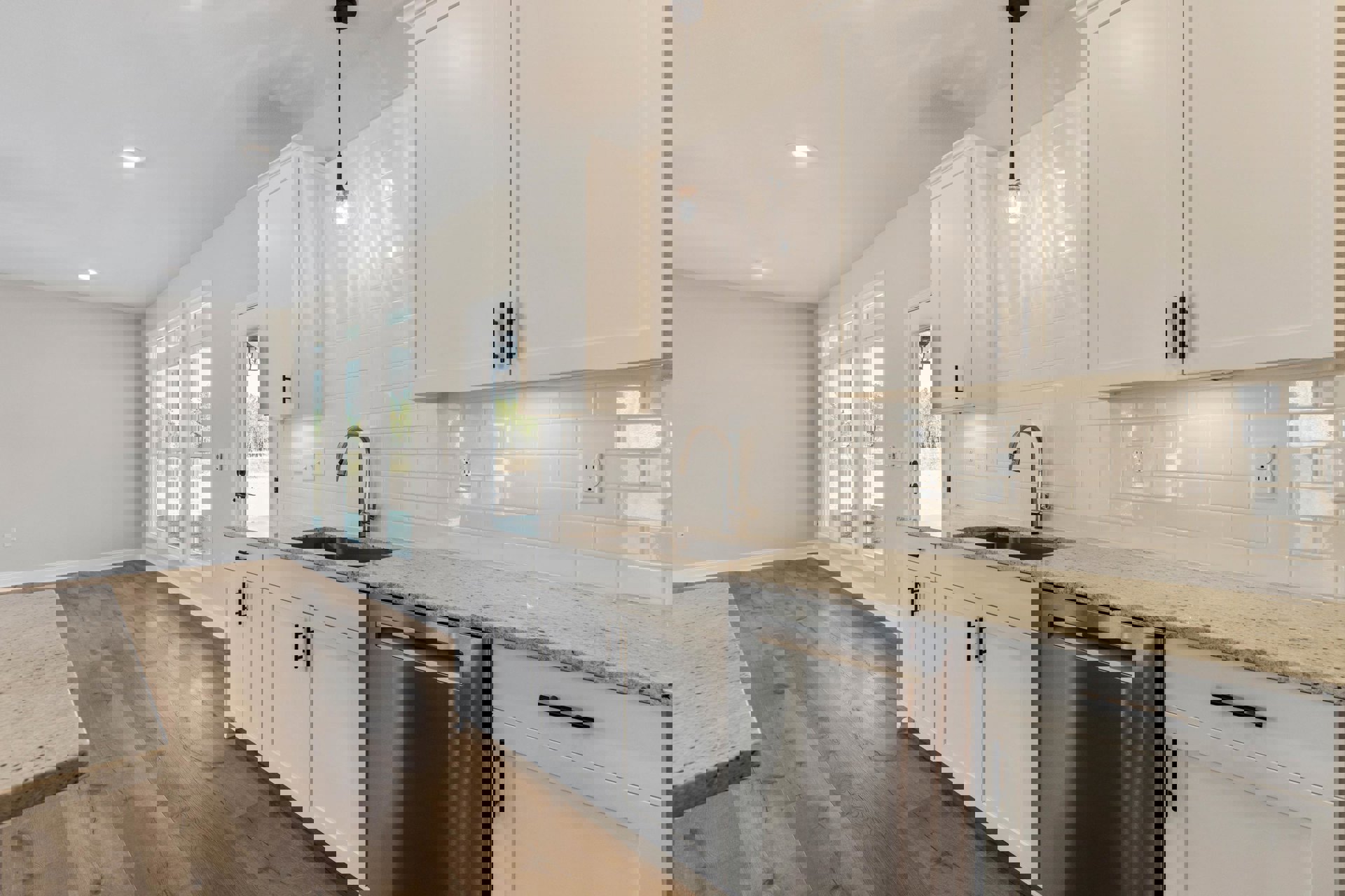 White kitchen cabinets, marble countertop, stainless steel dishwasher, chrome faucet, white tile backsplash, light wood flooring