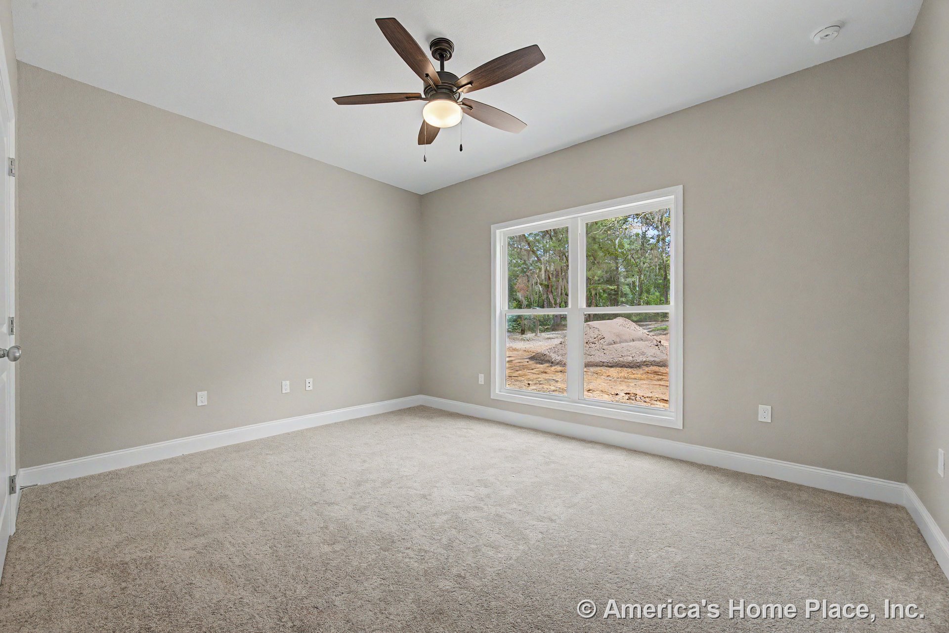 Bedroom with double window framed in white trim, neutral carpet flooring, ceiling fan and light fixture, light gray walls, white baseboards, and multiple electrical outlets.