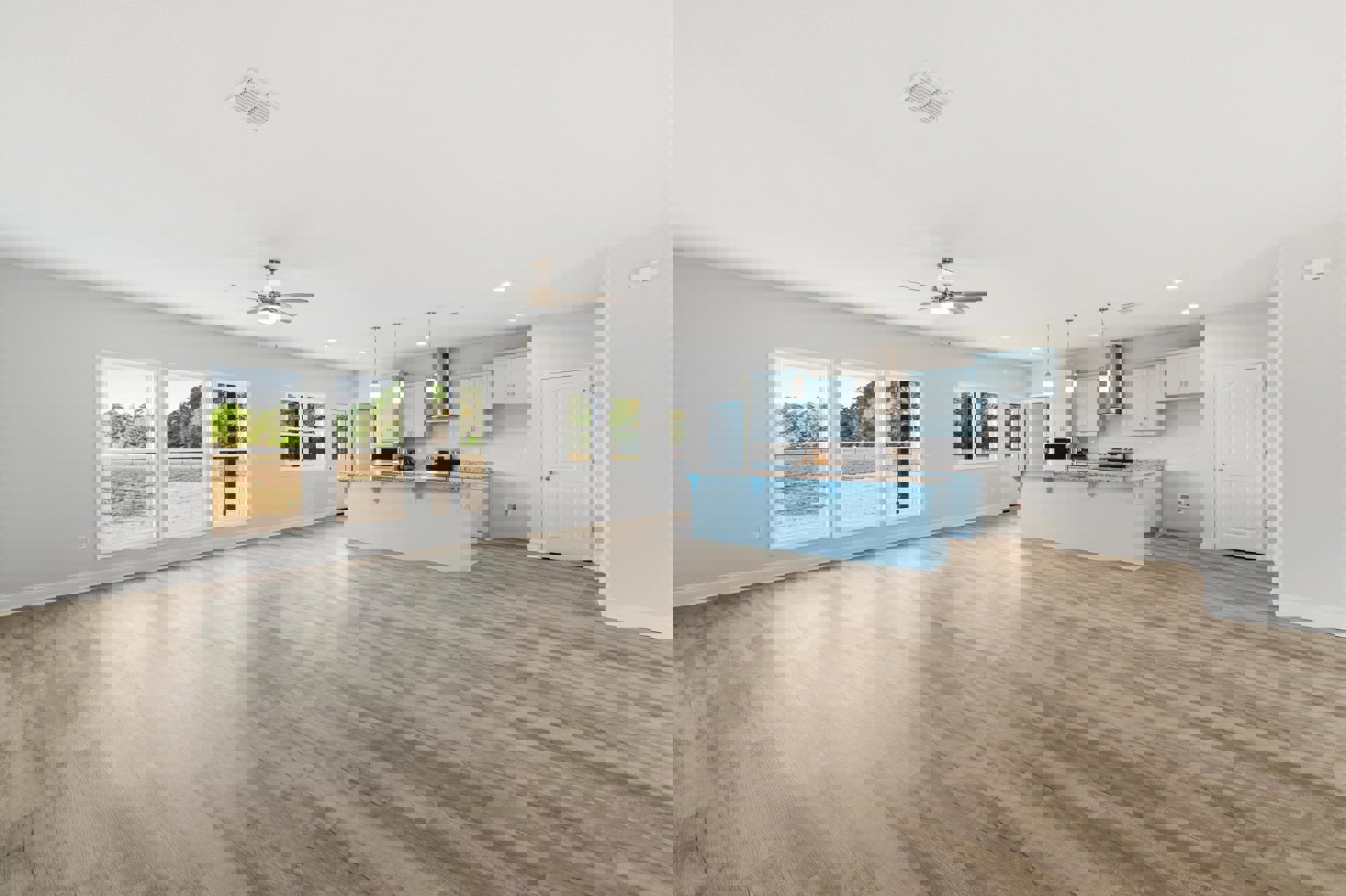 Open-concept kitchen with wood flooring, blue accent wall, white door with gold handle, ceiling fan with light, and ceiling vent