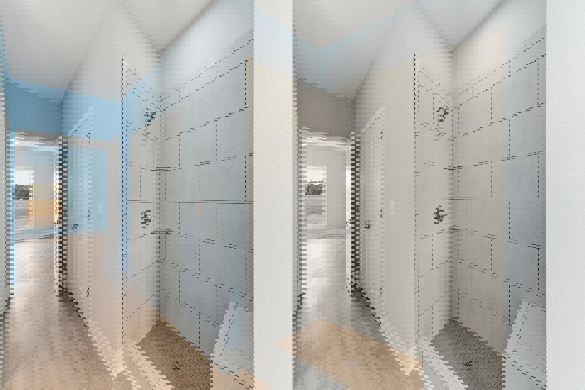 Bathroom with wood flooring, glass shower enclosure featuring tile walls, window overlooking trees, modern door handle, and shower drain visible on floor