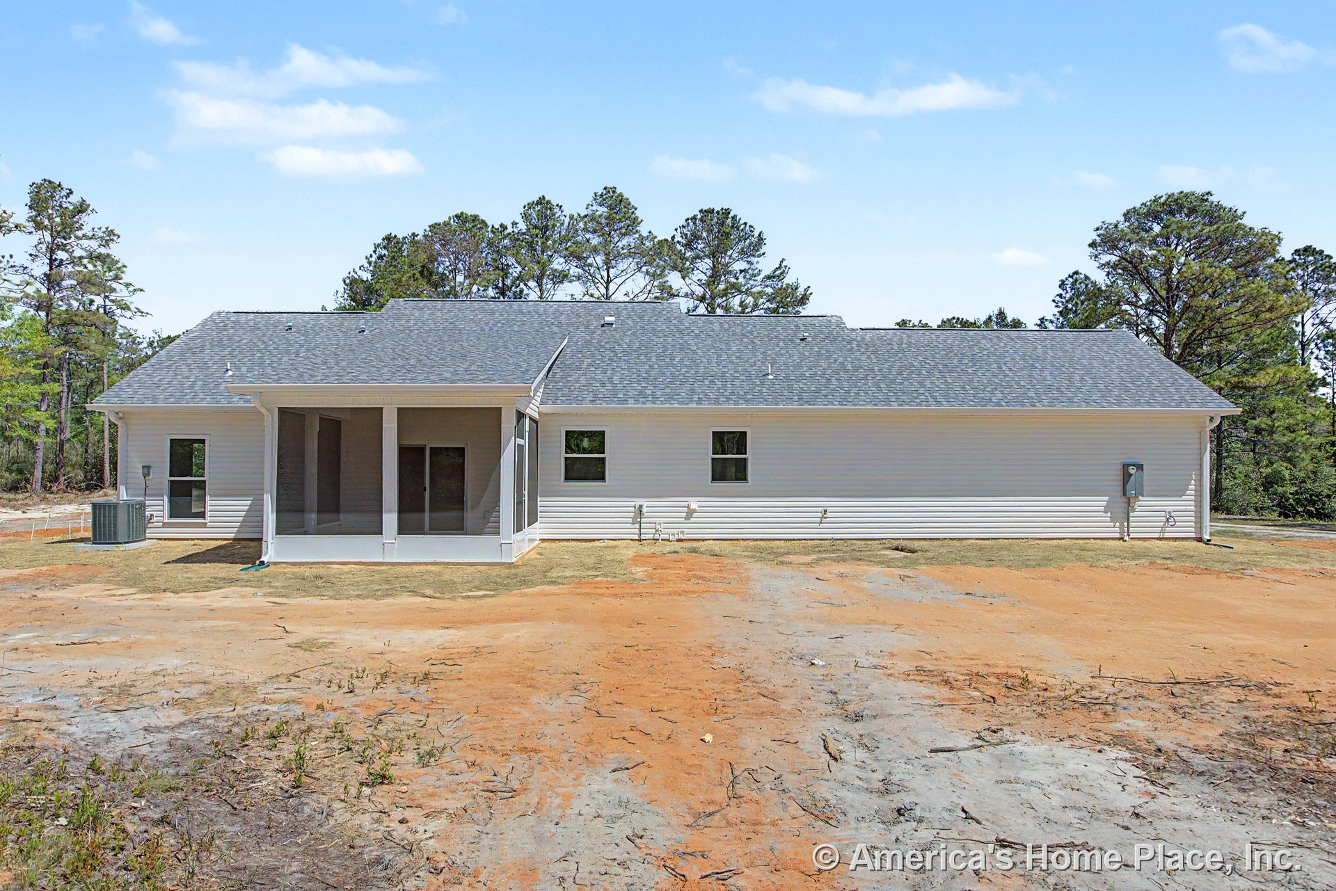 Screened-in back porch with white columns, vinyl siding exterior, multiple windows, gray shingle roof, exterior HVAC unit, and backyard utility connections.