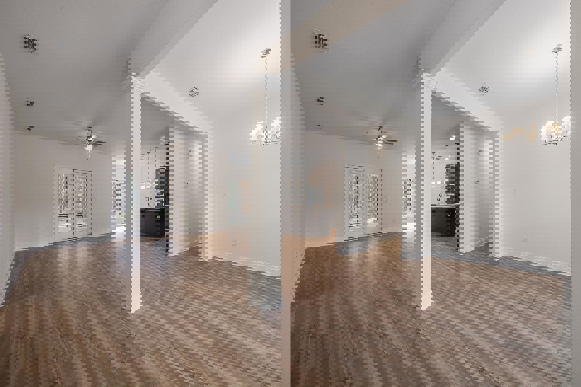 Wood flooring with white pillars, double glass doors, ceiling fan, black and white countertops, and cabinetry in a bright residential interior.