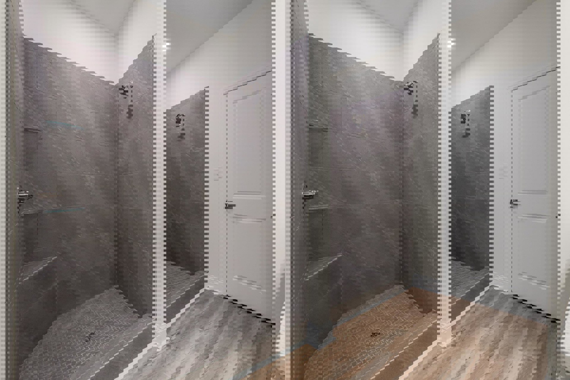 Walk-in shower with built-in bench, silver shower head, white tile walls, tile flooring, and a white door with silver handle