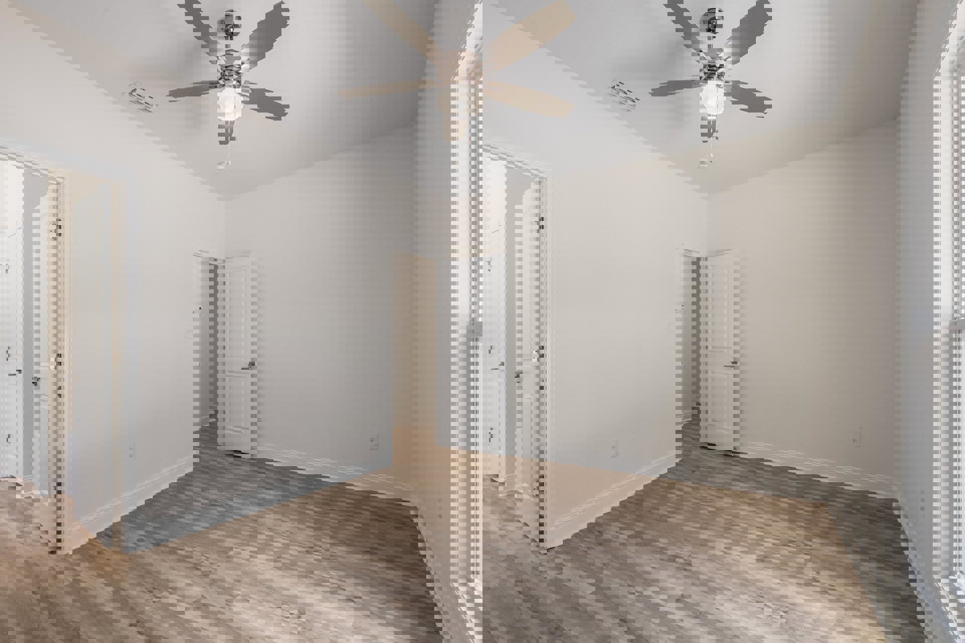 Ceiling fan with light fixture mounted on white plaster ceiling, wood flooring, white door with silver handle, simple baseboard molding