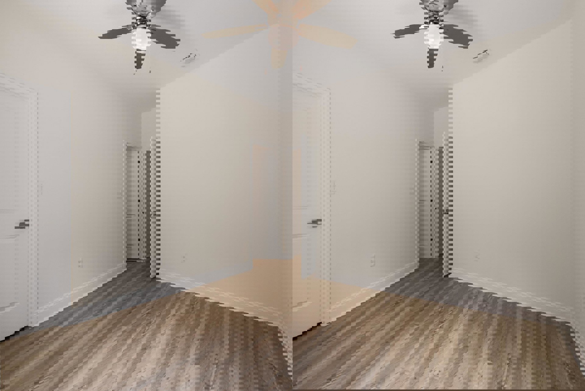 Ceiling fan with light fixture, wood flooring, white walls, white door with black handle, ceiling vent