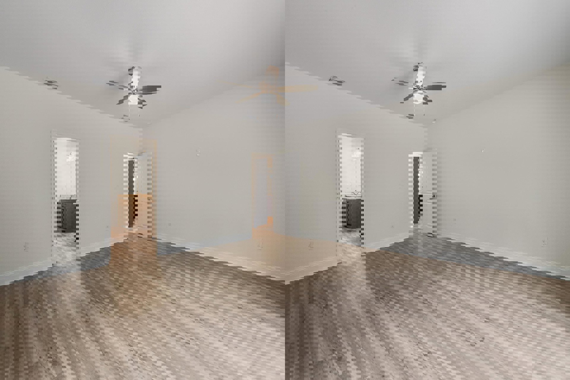 Ceiling fan with integrated light fixture, wood plank flooring, white walls, open white door with silver handle, partial view of bathroom sink