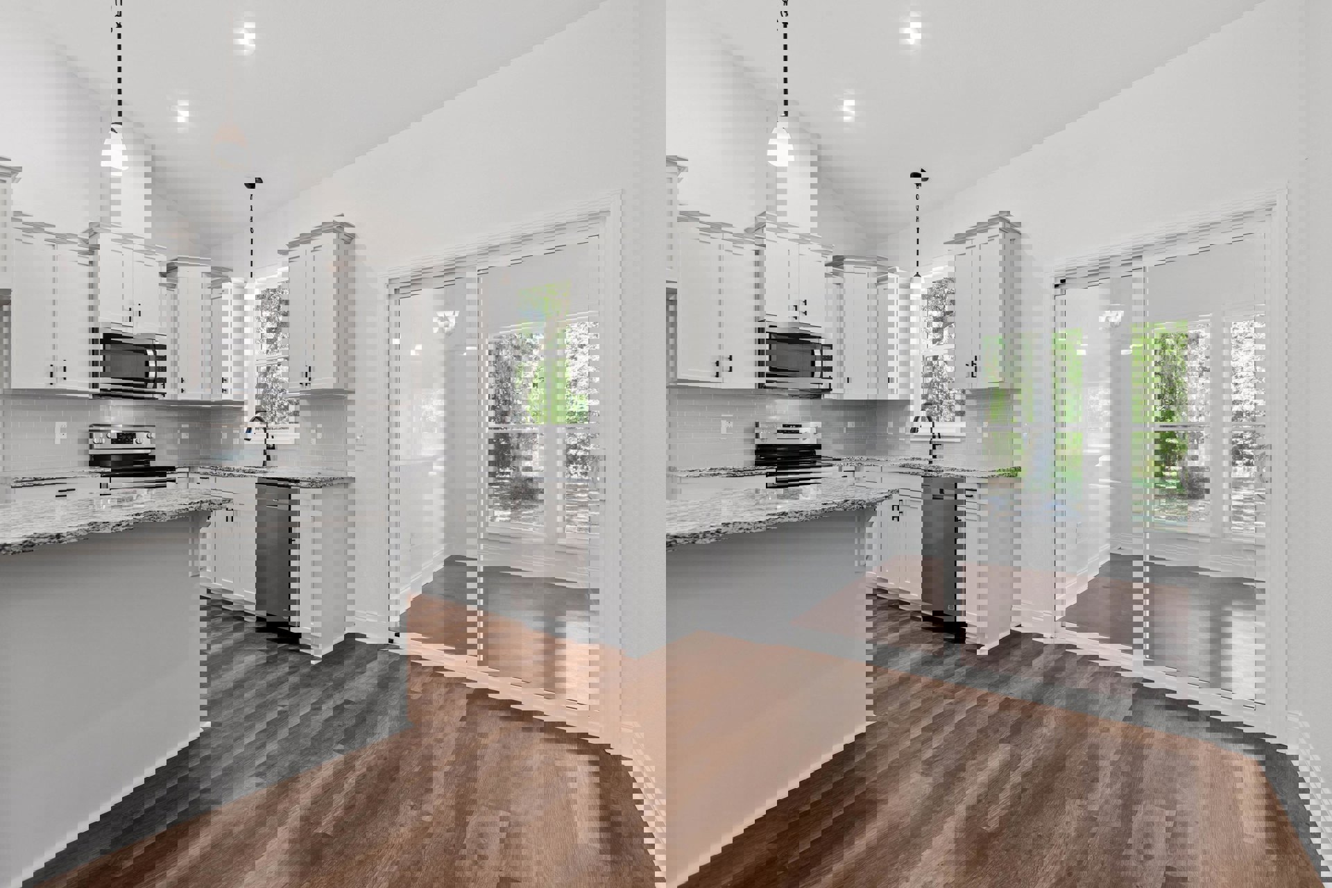 Modern kitchen featuring marble countertops, white cabinetry, wooden flooring, stainless steel refrigerator, built-in microwave with glass door, and a glass door leading outside.