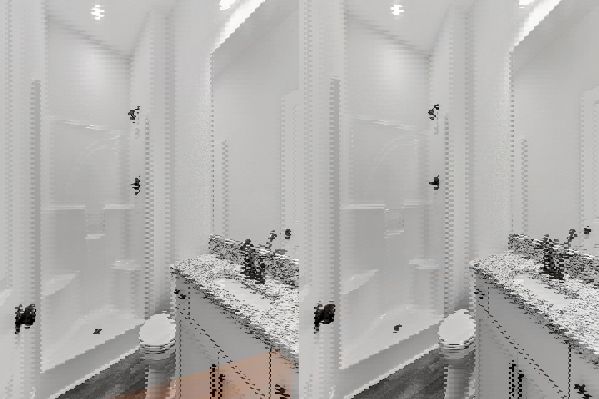 Modern bathroom featuring a glass-enclosed shower with curved chrome shower head, white porcelain sink set in a light-colored vanity, wall-mounted mirror, and closed white toilet