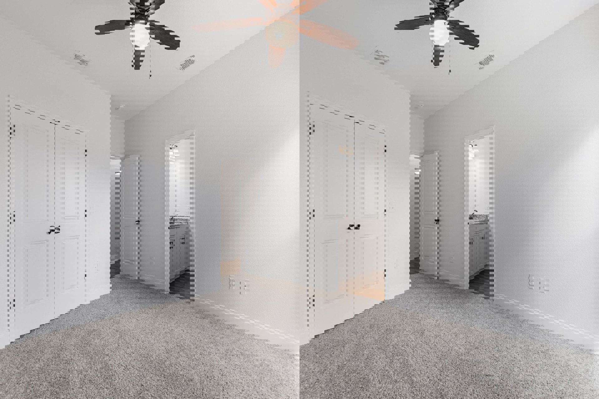 Carpeted room with white walls, ceiling fan with light, and white double doors featuring black knobs