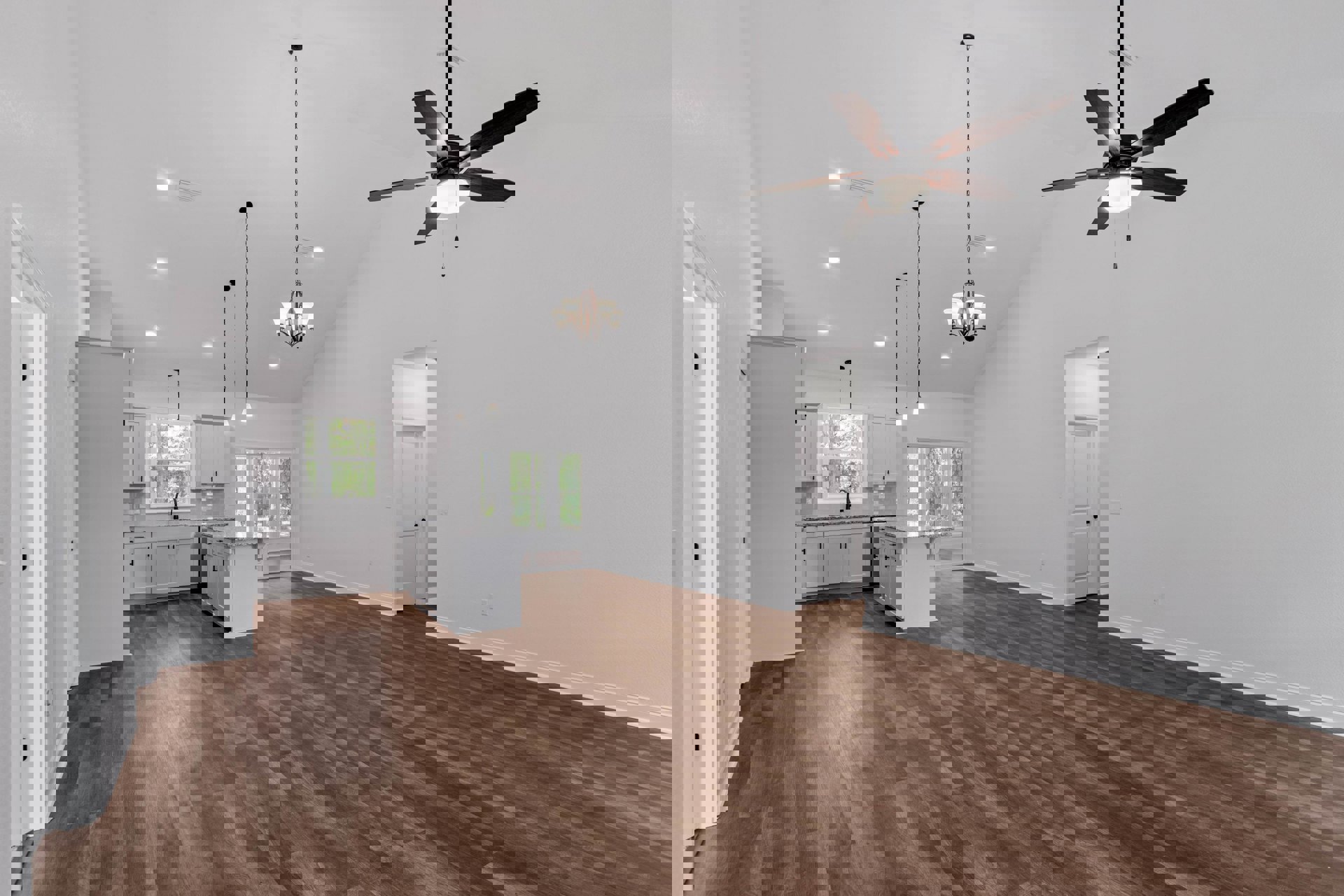 Open-concept room with wood flooring, ceiling fan with light, kitchen island featuring granite countertops, white door with black knob, and kitchen sink beneath a pendant light