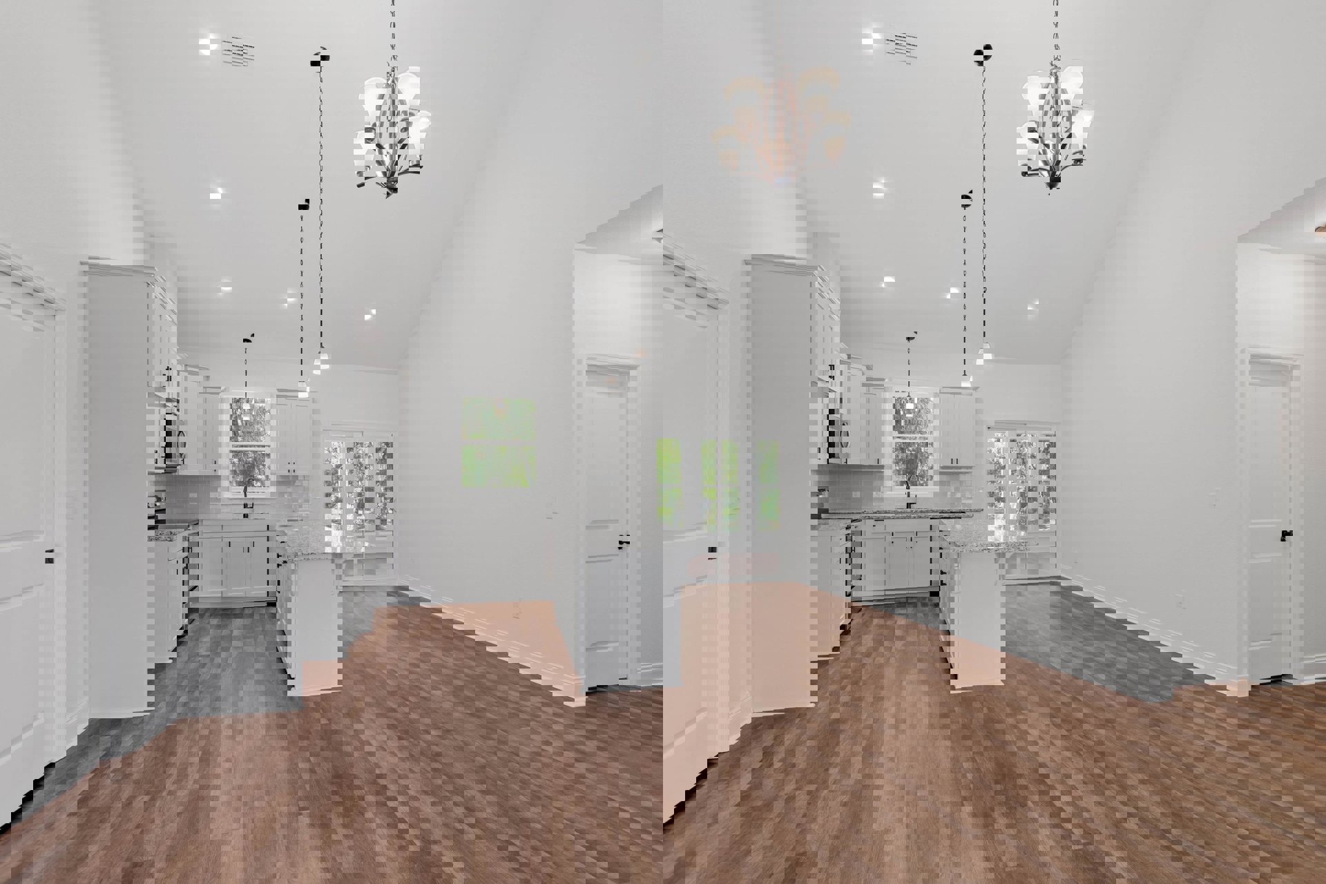 Open kitchen and dining area with hardwood floors, marble island, white cabinetry, five-light chandelier, and white door with black knob