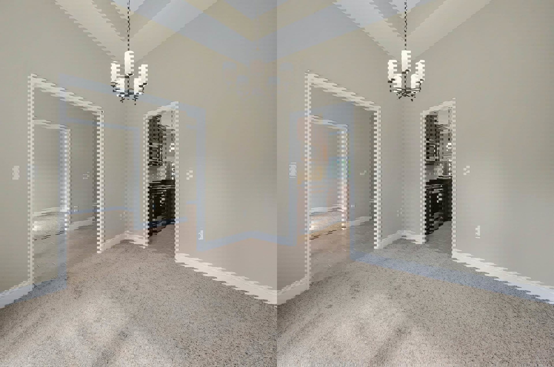 Chandelier with white lamps hanging above carpeted floor, built-in microwave on wall, close-up of stainless steel stove, white cabinetry, plaster walls, crown molding, and laminate