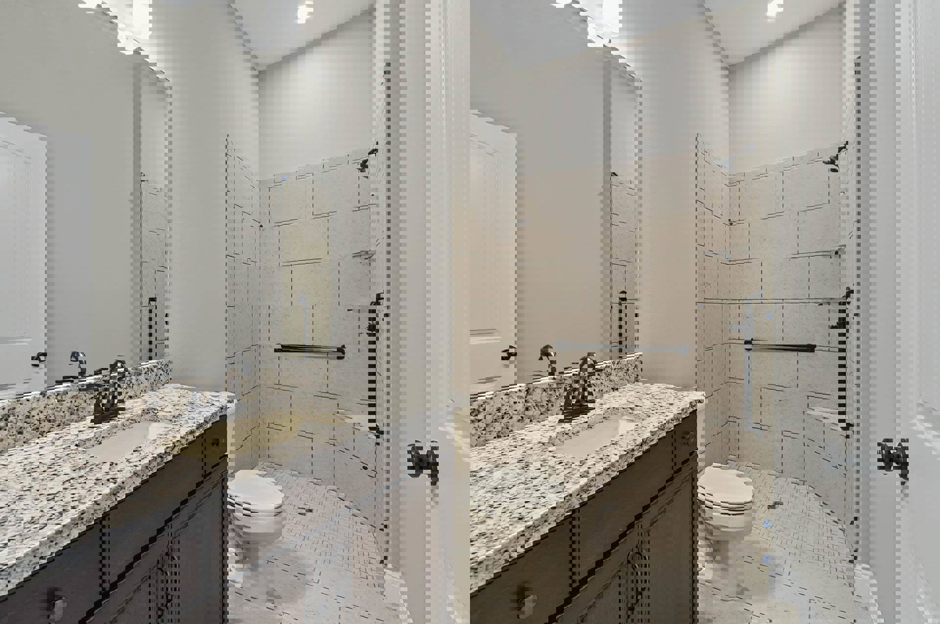 Modern bathroom featuring a white ceramic sink set in a wood vanity with stone countertop, rectangular mirror above, glass-enclosed shower with tile walls, and closed-lid toilet