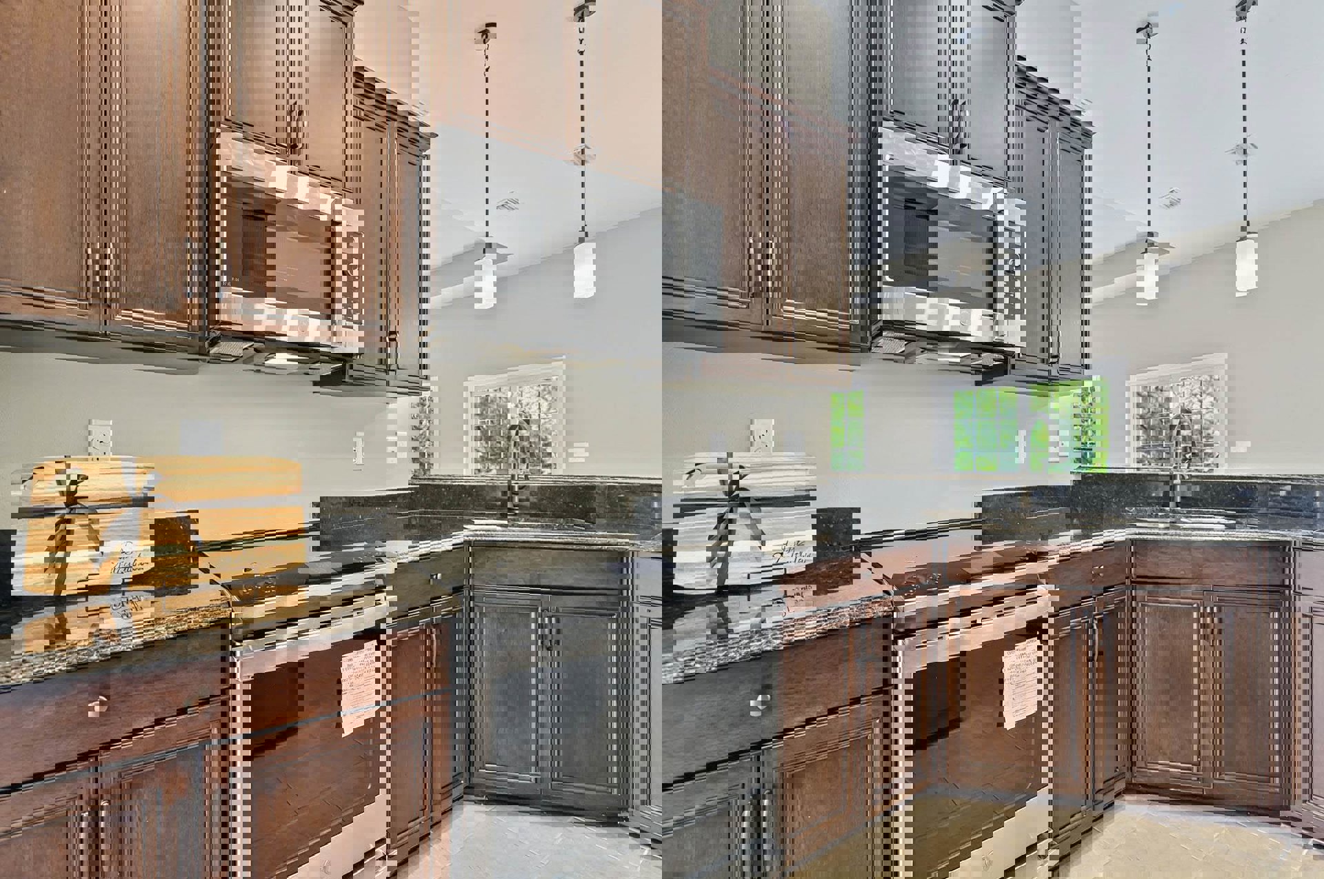 Kitchen featuring dark wood cabinetry, stainless steel appliances including a microwave and stove, stone countertops, modern faucet, and white electrical outlet.