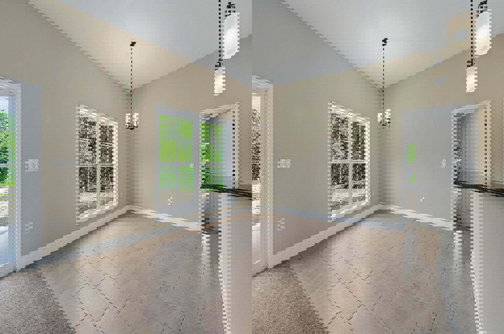 Brown tile flooring, white plaster walls, large window with white frame and black handle, view of trees outside, ceiling chain fixture, white door with black handle