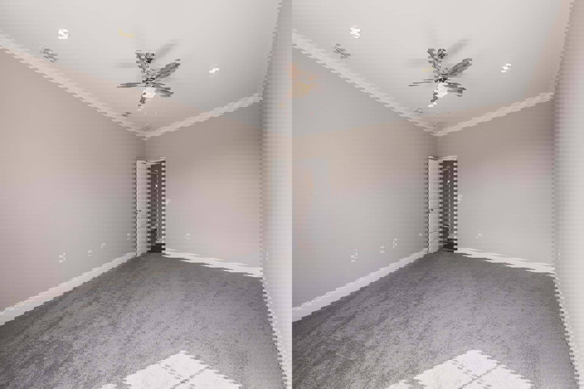 Bedroom with light gray walls, white trim, ceiling fan with light, white door with silver hardware, and vent on smooth plaster ceiling