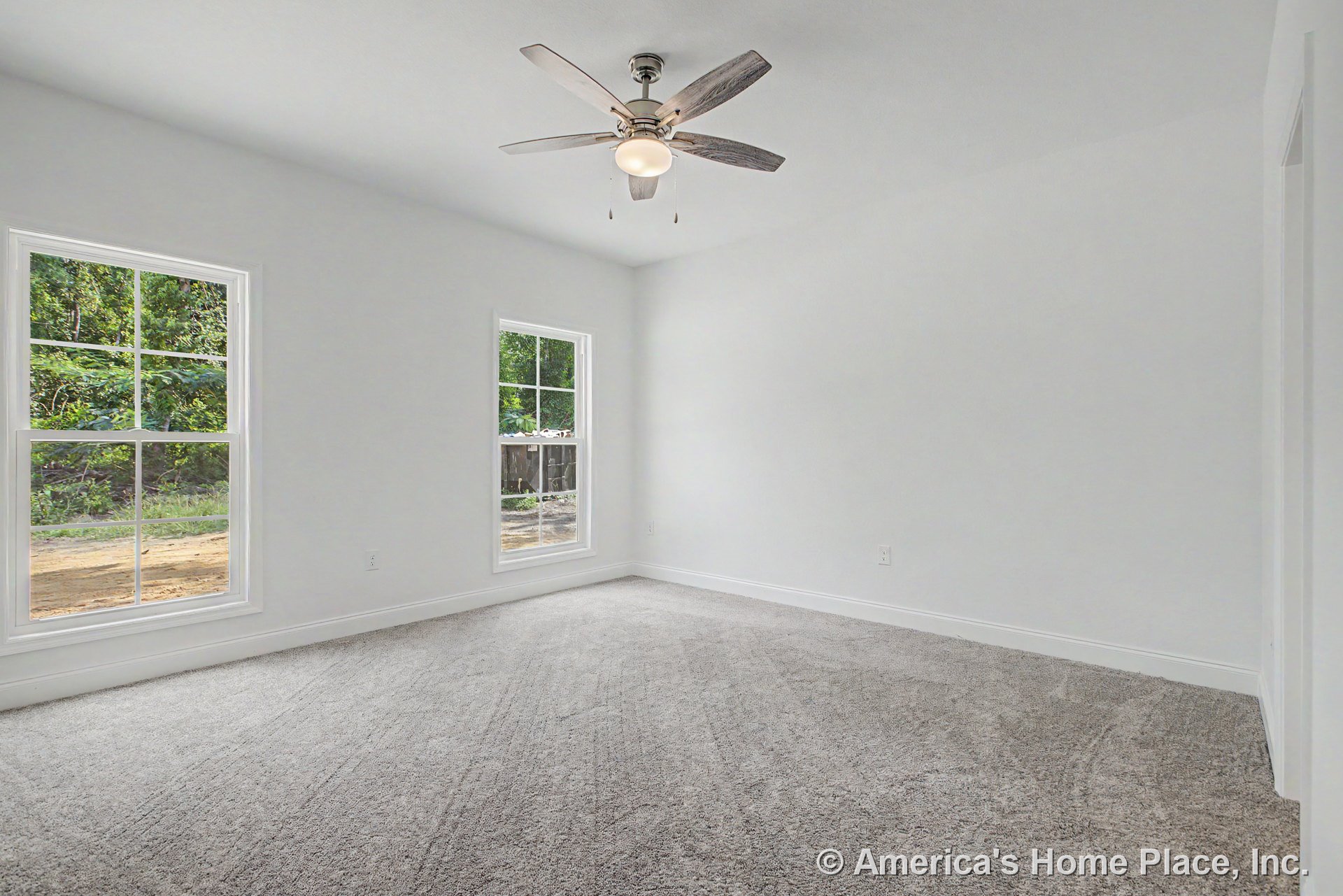 Bedroom with carpeted floor, neutral walls, double large windows with white trim, ceiling fan and light fixture, baseboard molding, and abundant natural light.
