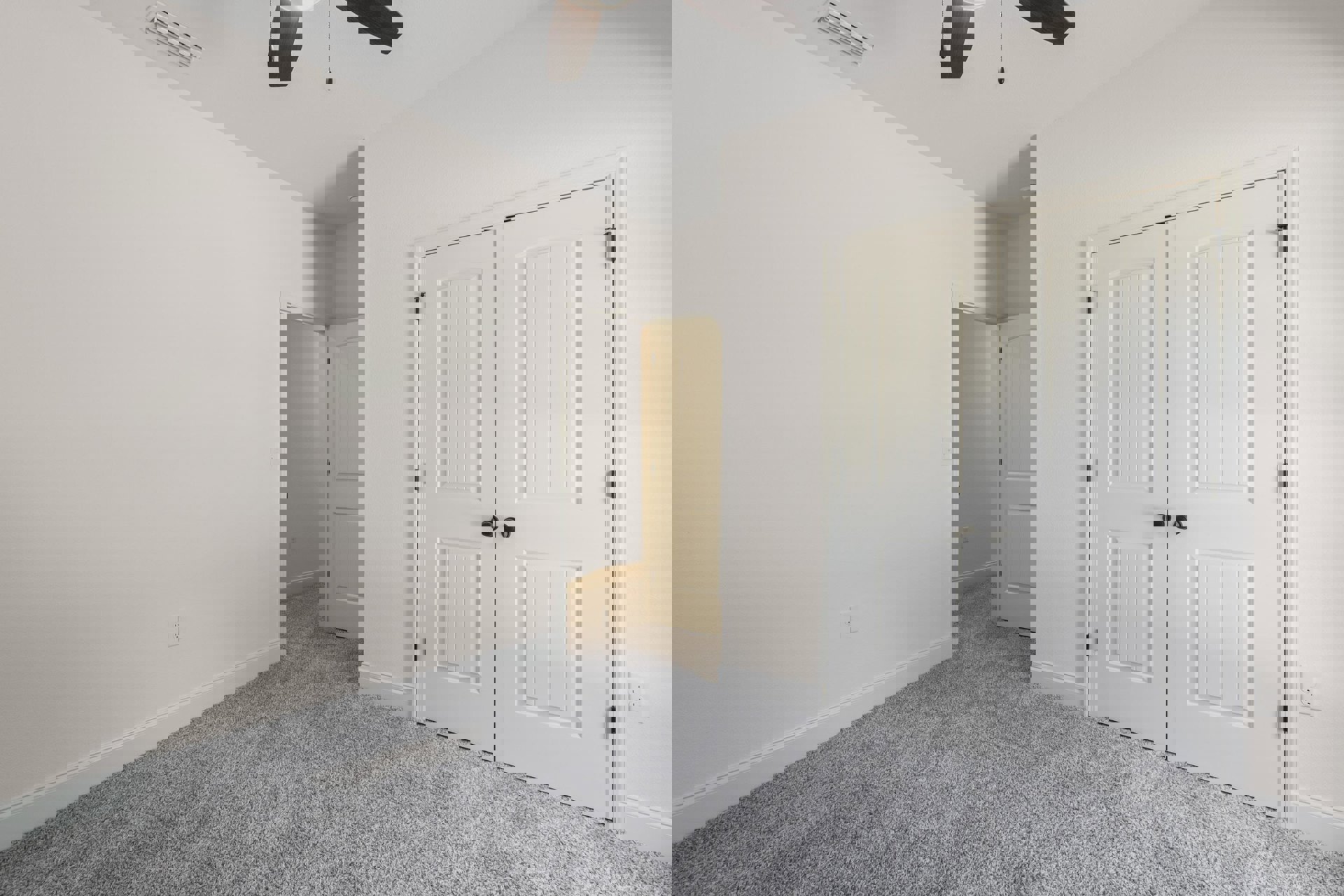 White-walled room with beige carpet, ceiling fan, white double doors with black knobs, single white door with black handle, and a black-accented light fixture