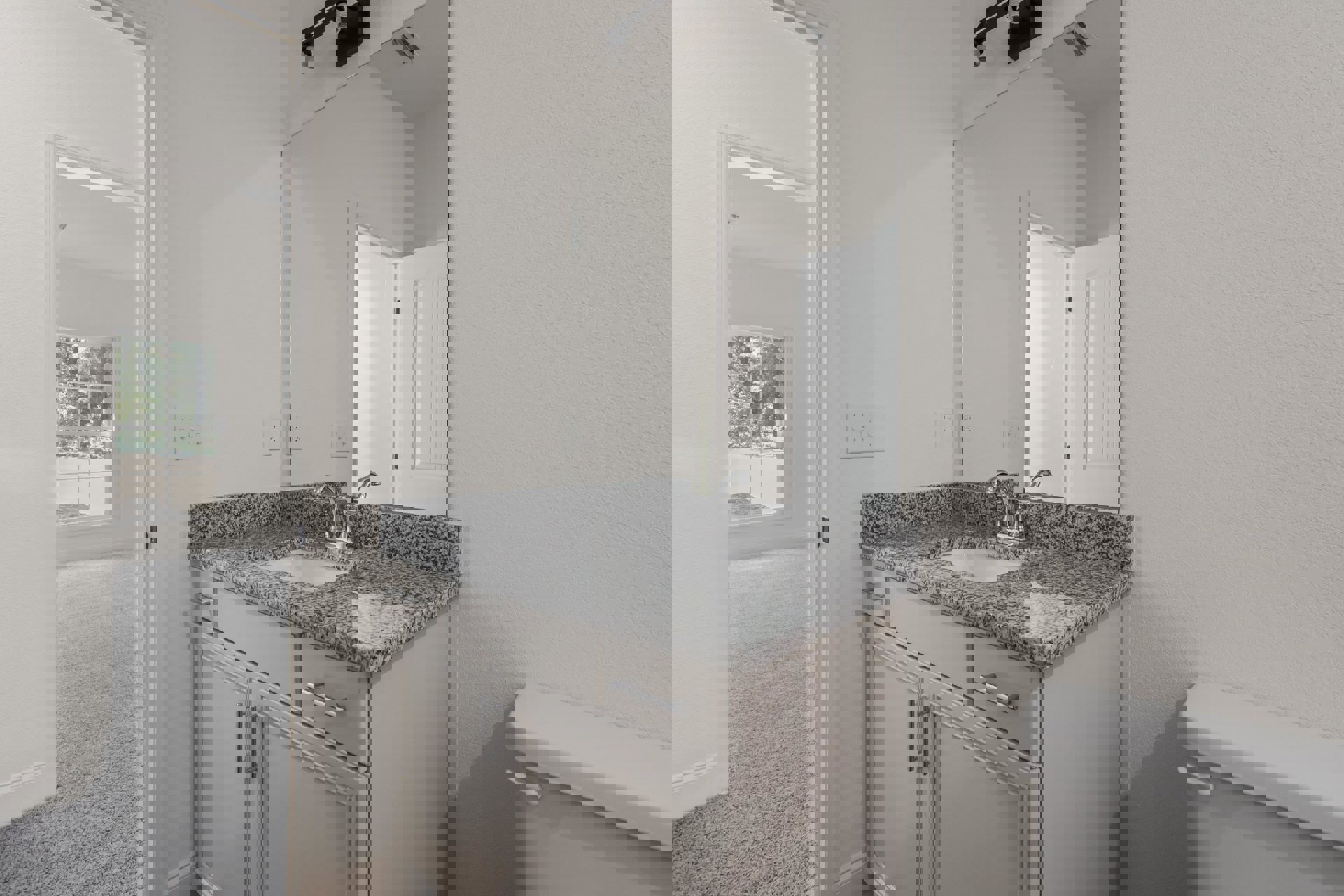 Modern bathroom featuring a rectangular mirror above a white sink with chrome faucet, light-colored tile backsplash, dark wood cabinetry, and a row of light switches on the wall.