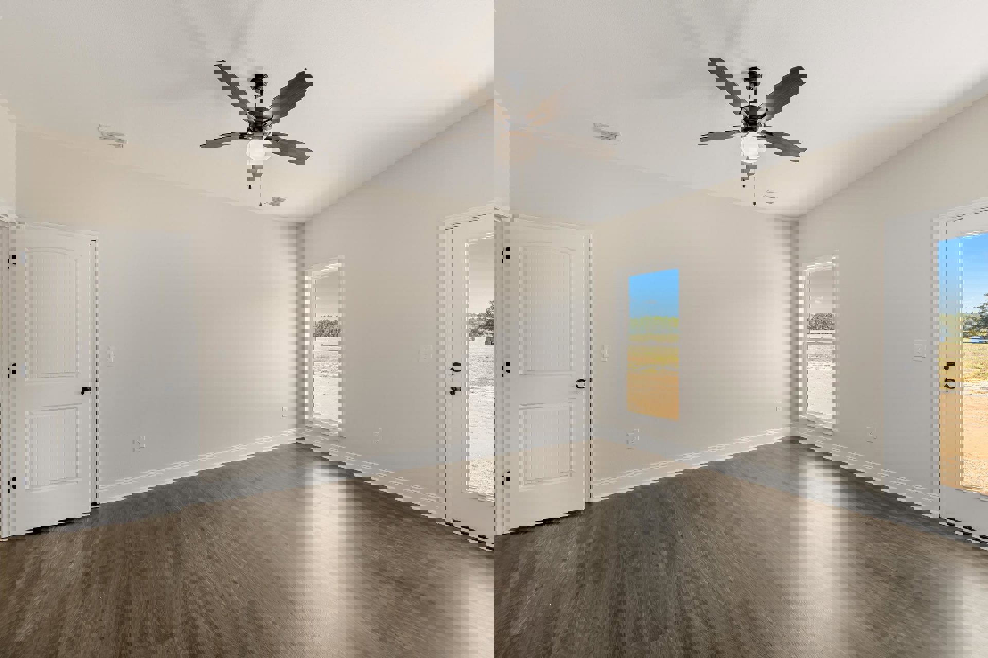 Ceiling fan with light fixture, wood laminate flooring, white door with black handles, window and door offering views of trees and open field, smooth plaster walls and ceiling