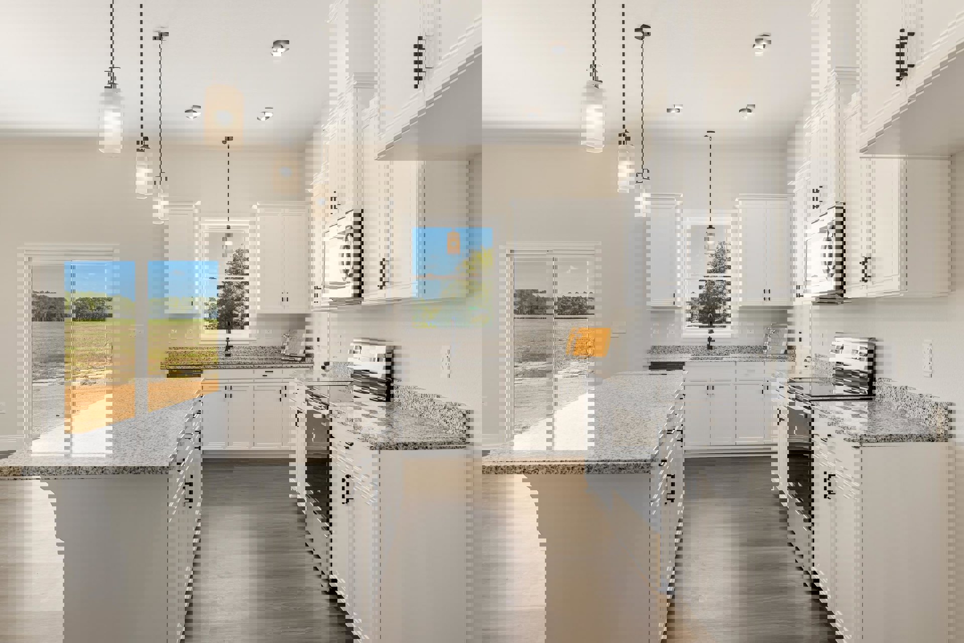 White kitchen cabinets and granite countertops, kitchen island facing sliding glass door with field view, window letting in natural light, built-in microwave, stainless sink