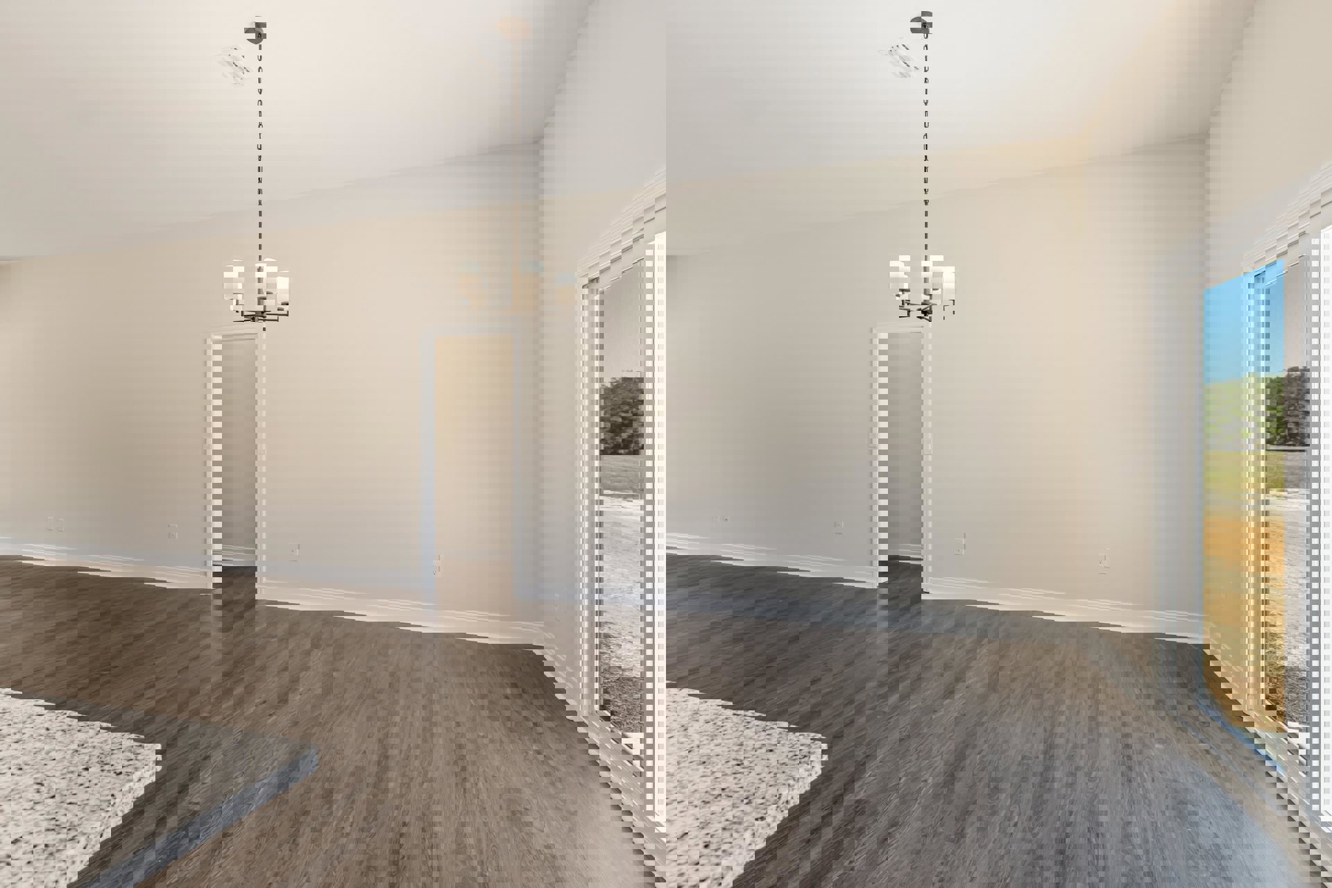 Hardwood flooring, white plaster walls, modern pendant light fixture, large window with outdoor view