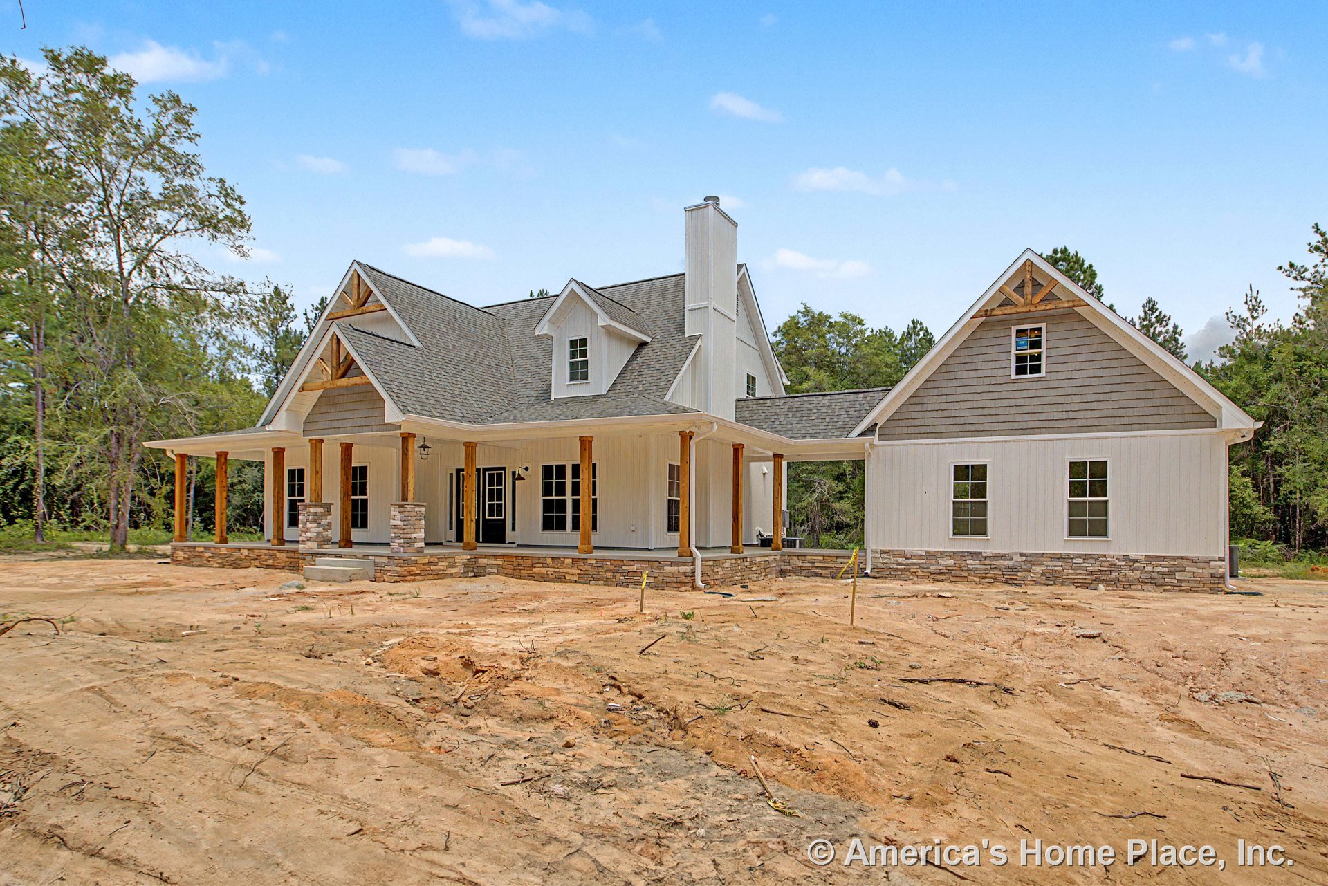 Large covered front porch with stone column bases, wooden support posts, lap siding exterior, multiple gable roofs, attached garage, prominent windows, brick chimney, permanent
