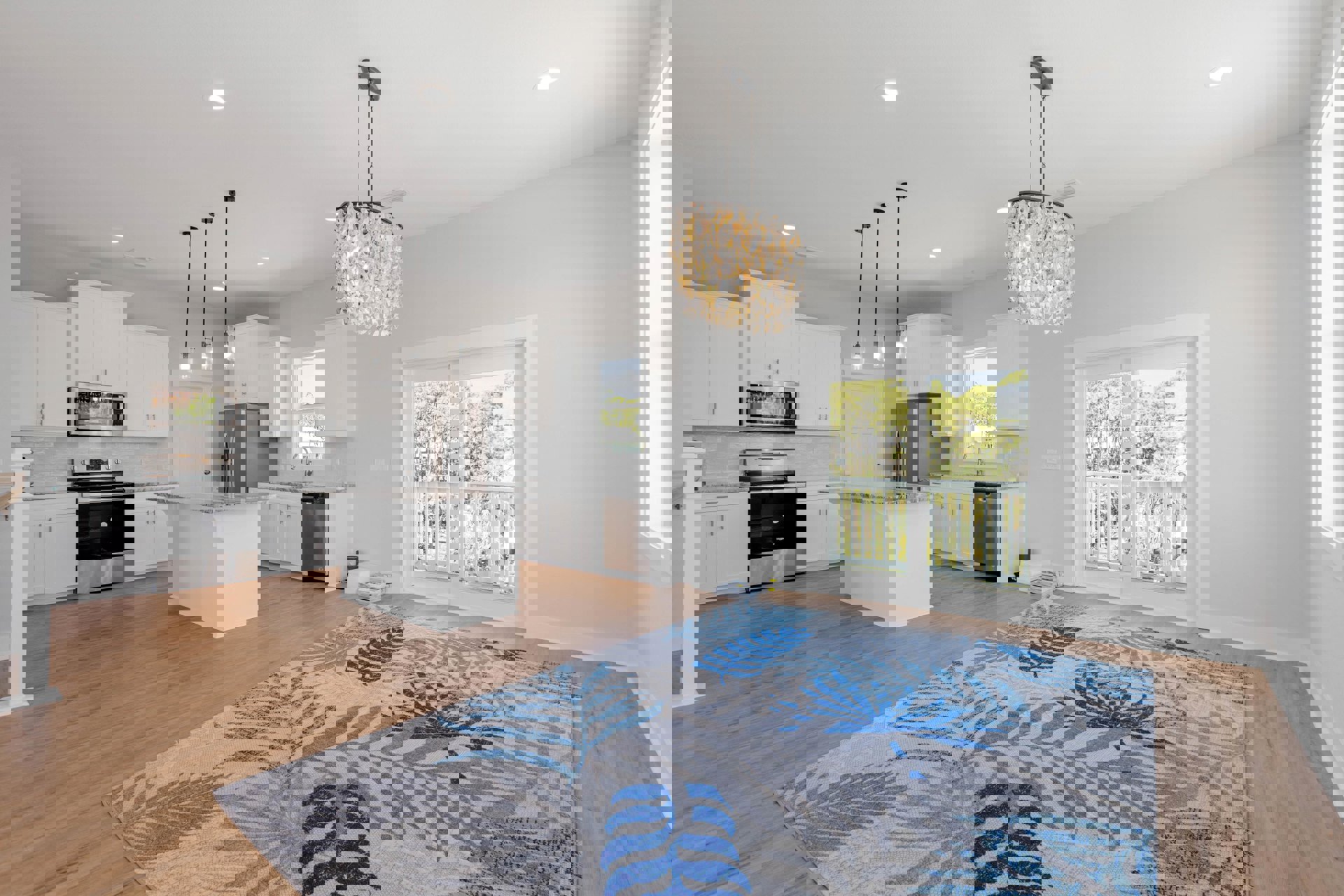 Open-concept kitchen and living room featuring laminate flooring, white cabinetry, stainless steel stove, oyster shell chandelier, area rug, sliding glass door leading to balcony