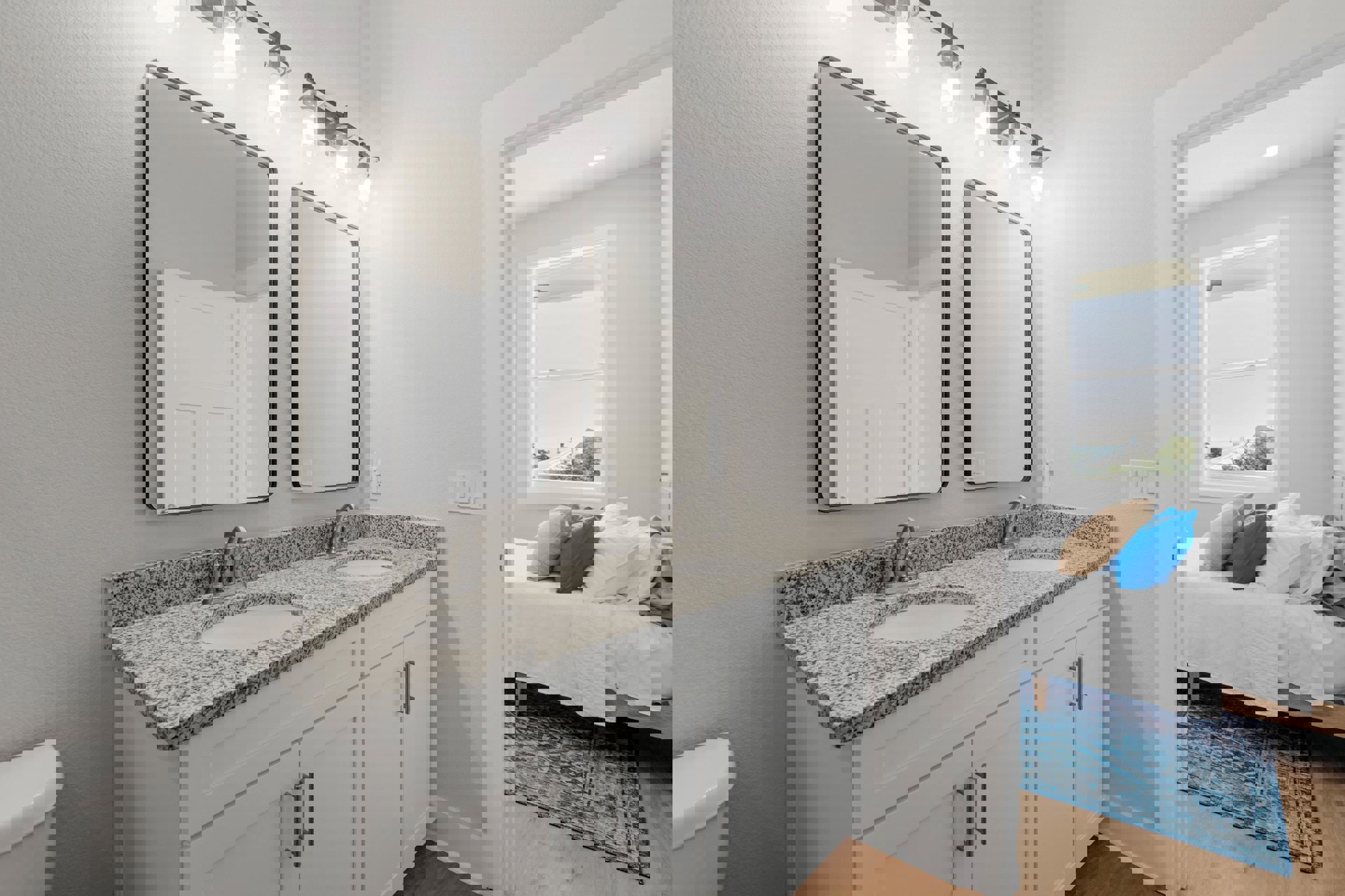 Bathroom with dual sinks set in a light stone countertop, matching framed mirrors above each sink, white cabinetry below, and neutral tile backsplash.