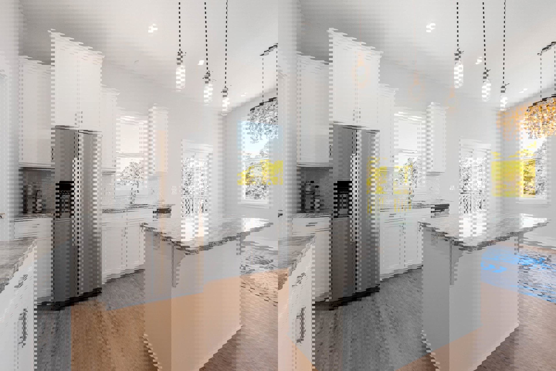 Kitchen with stainless steel refrigerator, open door revealing shelves, wood flooring, marble-topped island, cabinetry, window showing trees, rug detail, and wall-mounted light