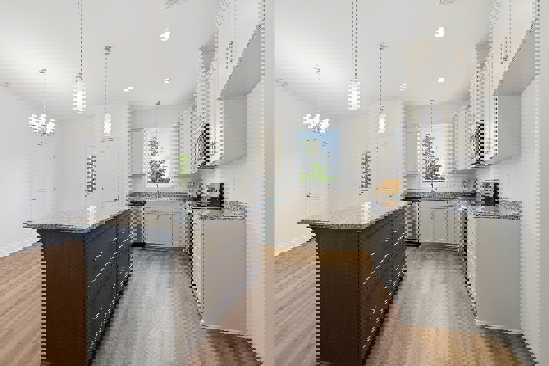 White kitchen with granite countertops, shaker cabinets, stainless steel sink, kitchen island with drawers, pendant light fixture above window, hardwood flooring, and a white