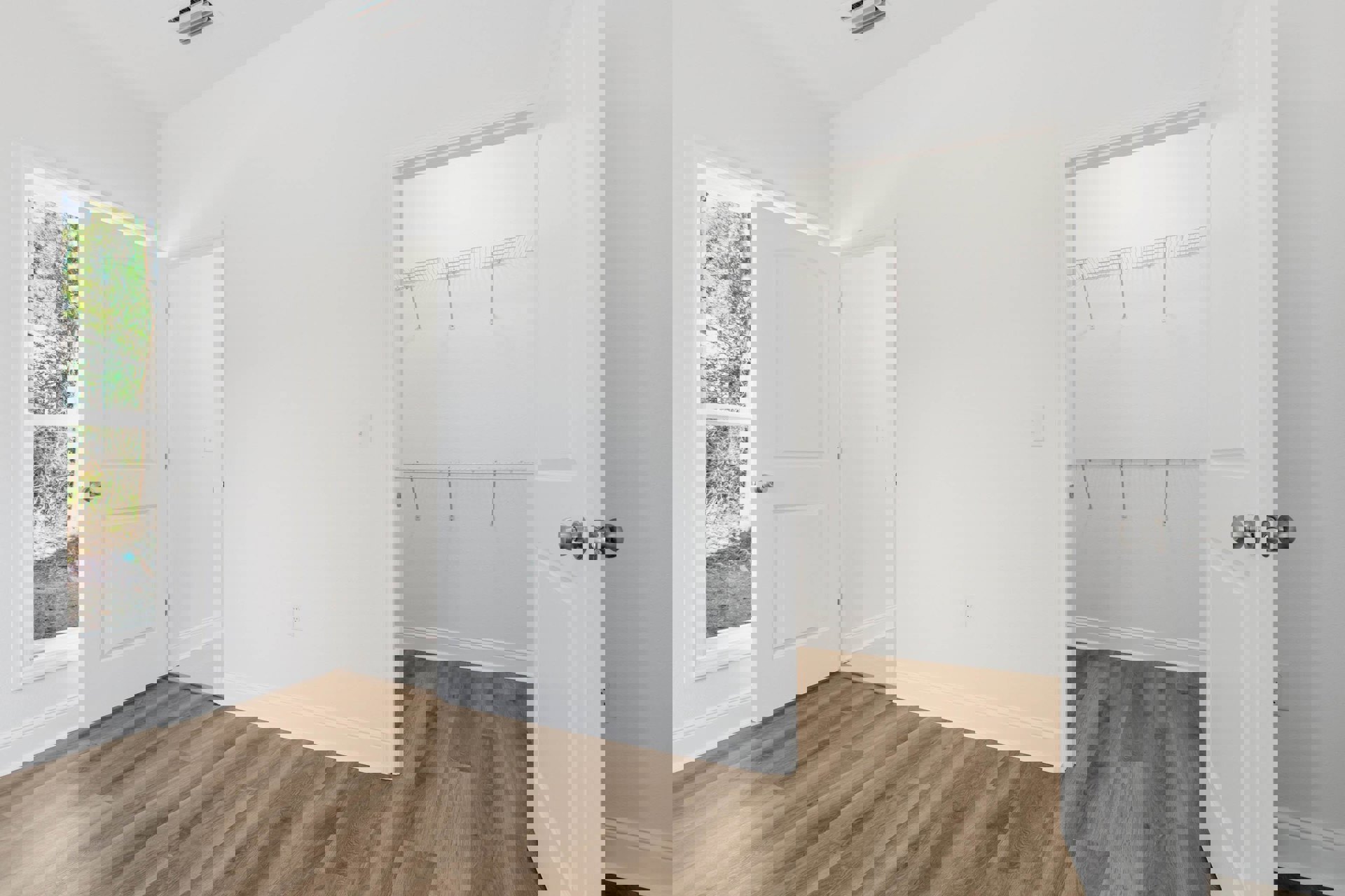 White-walled room with wood flooring, white baseboards, a white door featuring a silver knob, and a closet with metal shelving.