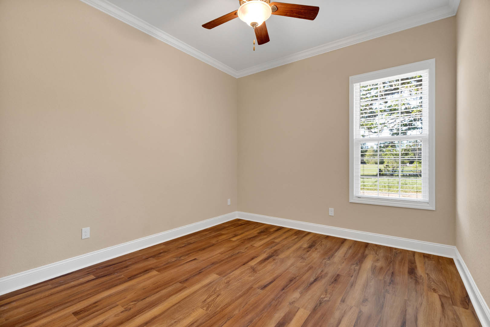 Ceiling fan with light fixture, wood flooring with white baseboards, window with closed blinds, smooth plaster walls